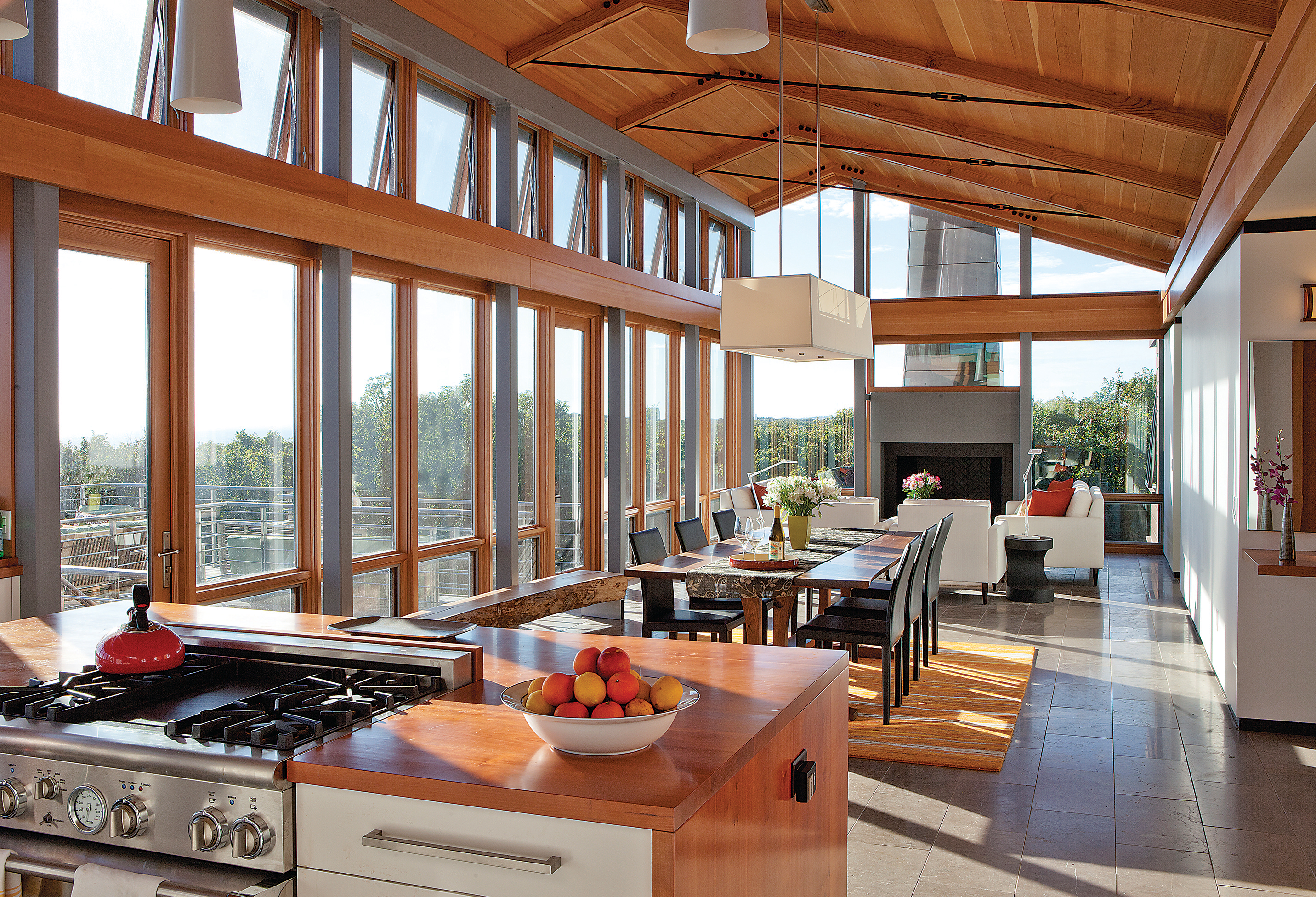 The 2,000-square-foot home includes an open kitchen, dining, and living area with floor-to-ceiling windows.