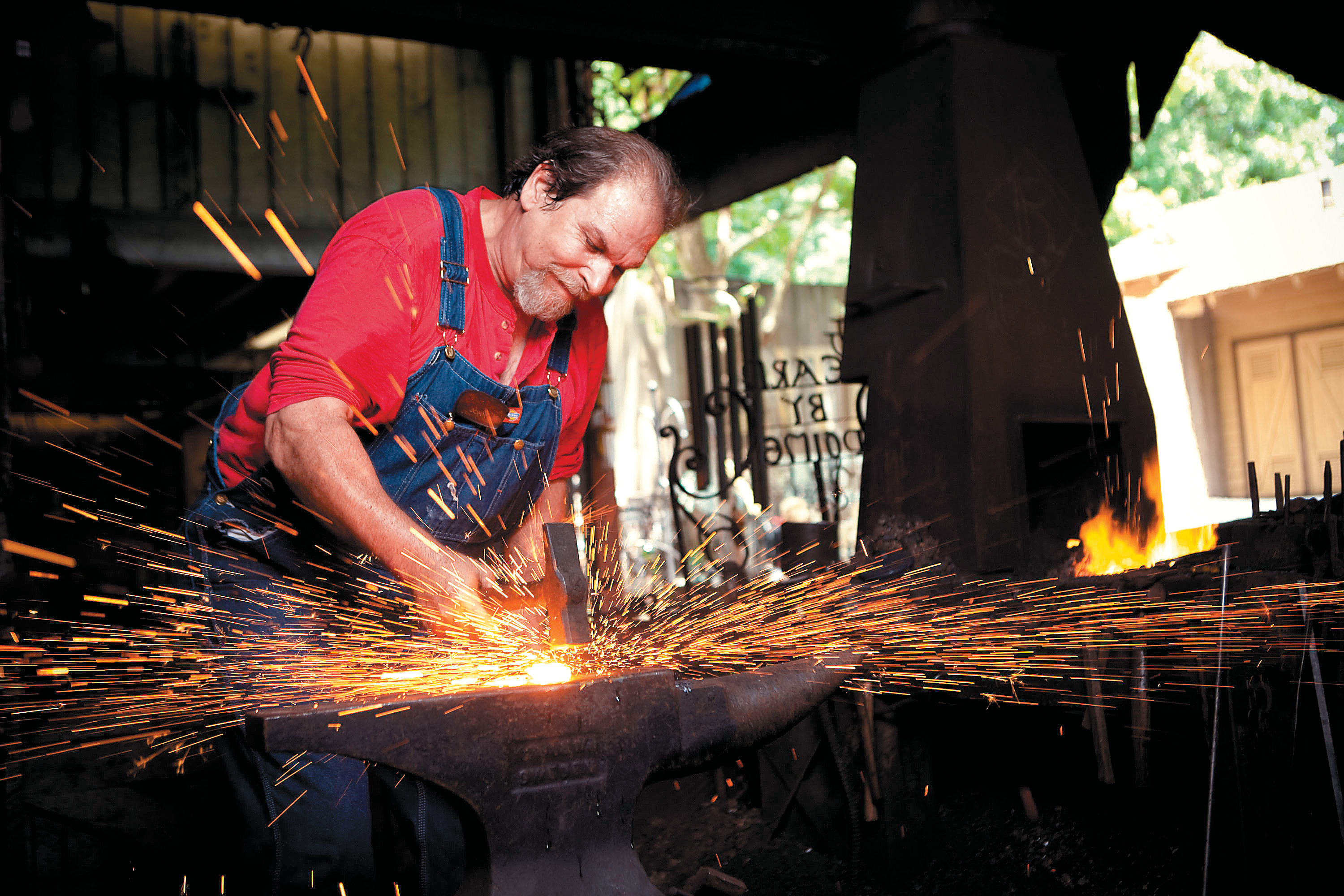 A blacksmith plies his trade.