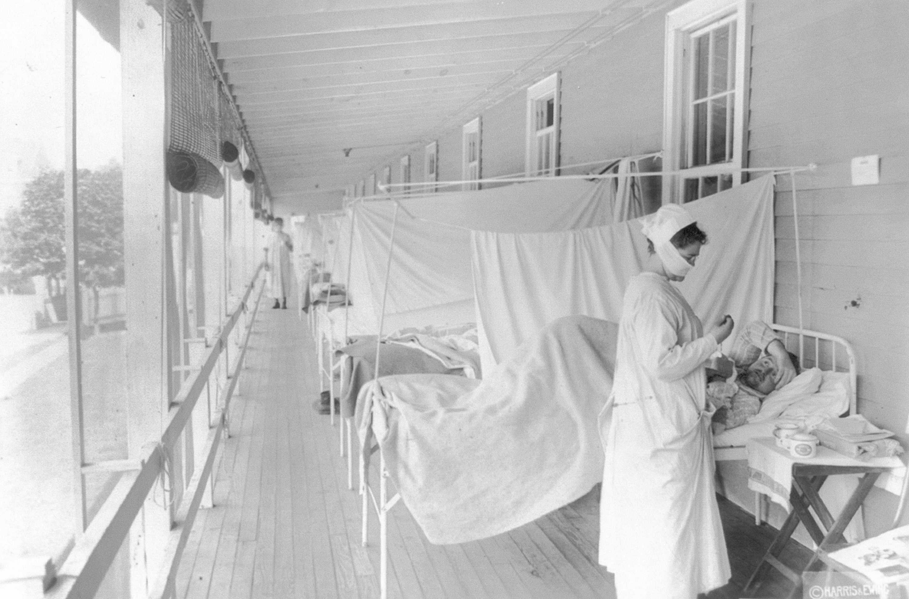 A nurse took the pulse of a patient in the influenza ward of the Walter Reed hospital in Washington in 1918.