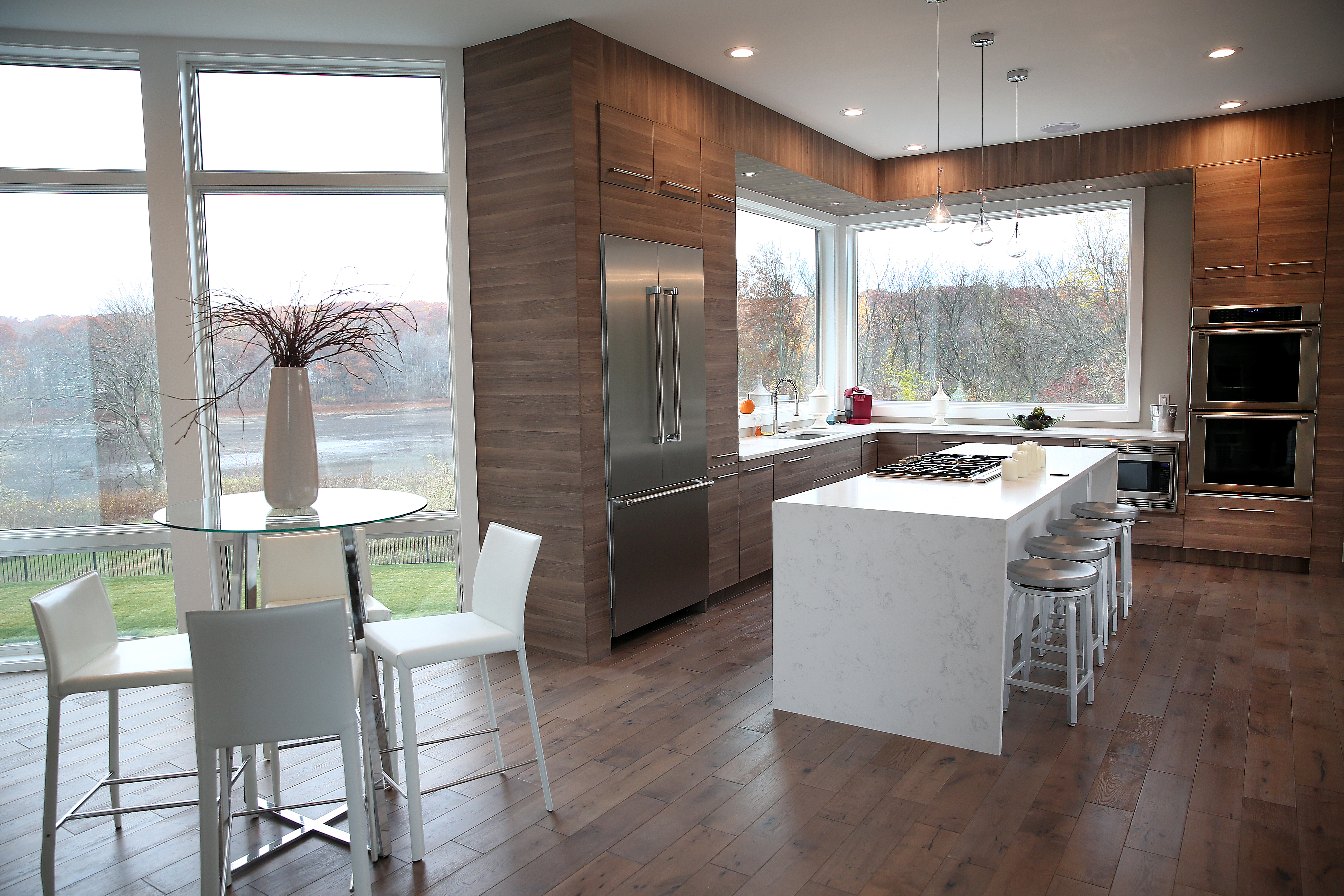 The kitchen features a waterfall-style granite counter, a faux-wood treatment on the walls and cabinetry, and a view of Dry Pond.