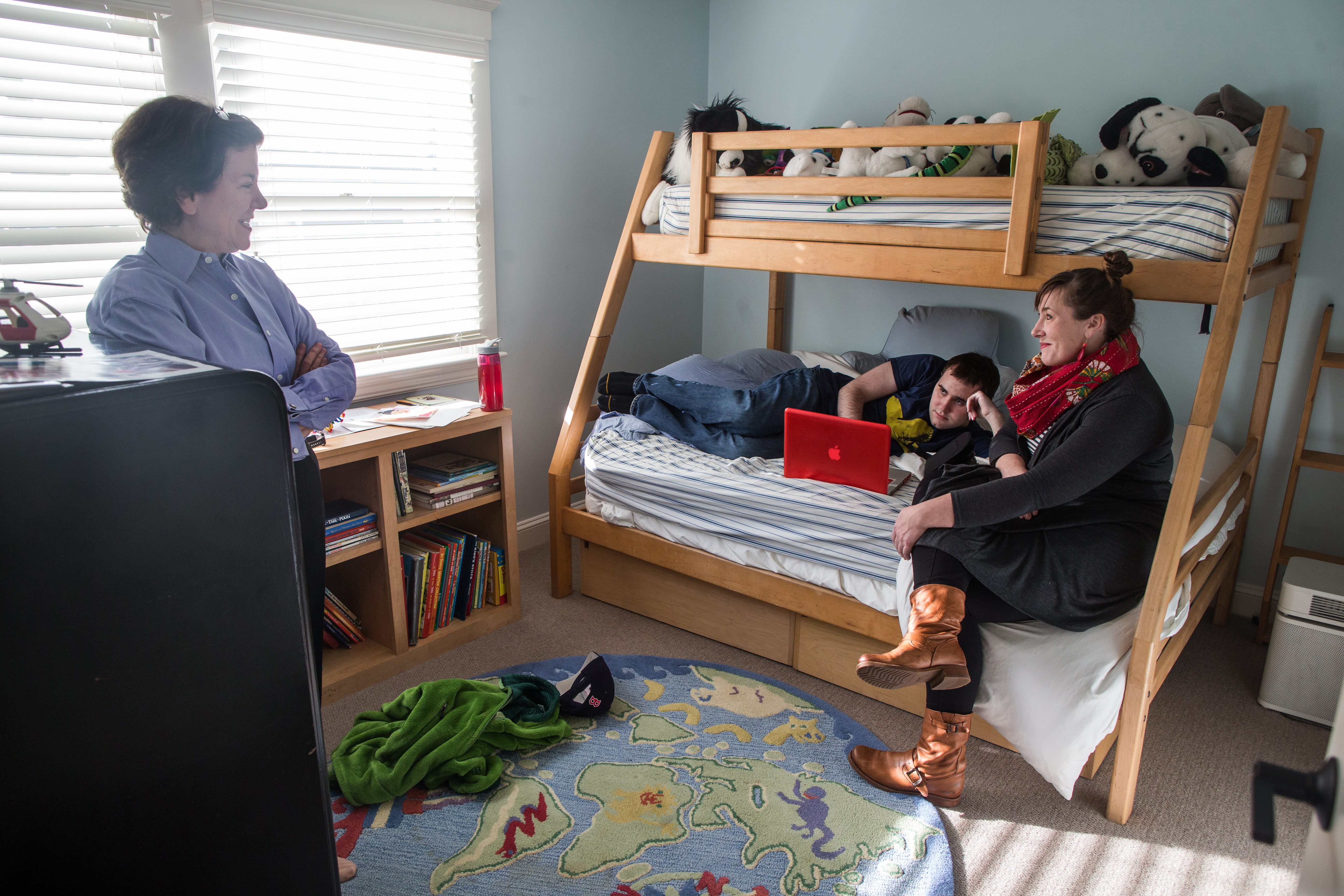 Deborah Flaschen, (far left) with her son, D.J., and expressive arts therapist Meghan Montgomery in D.J.’s room at 3LPlace Life College.