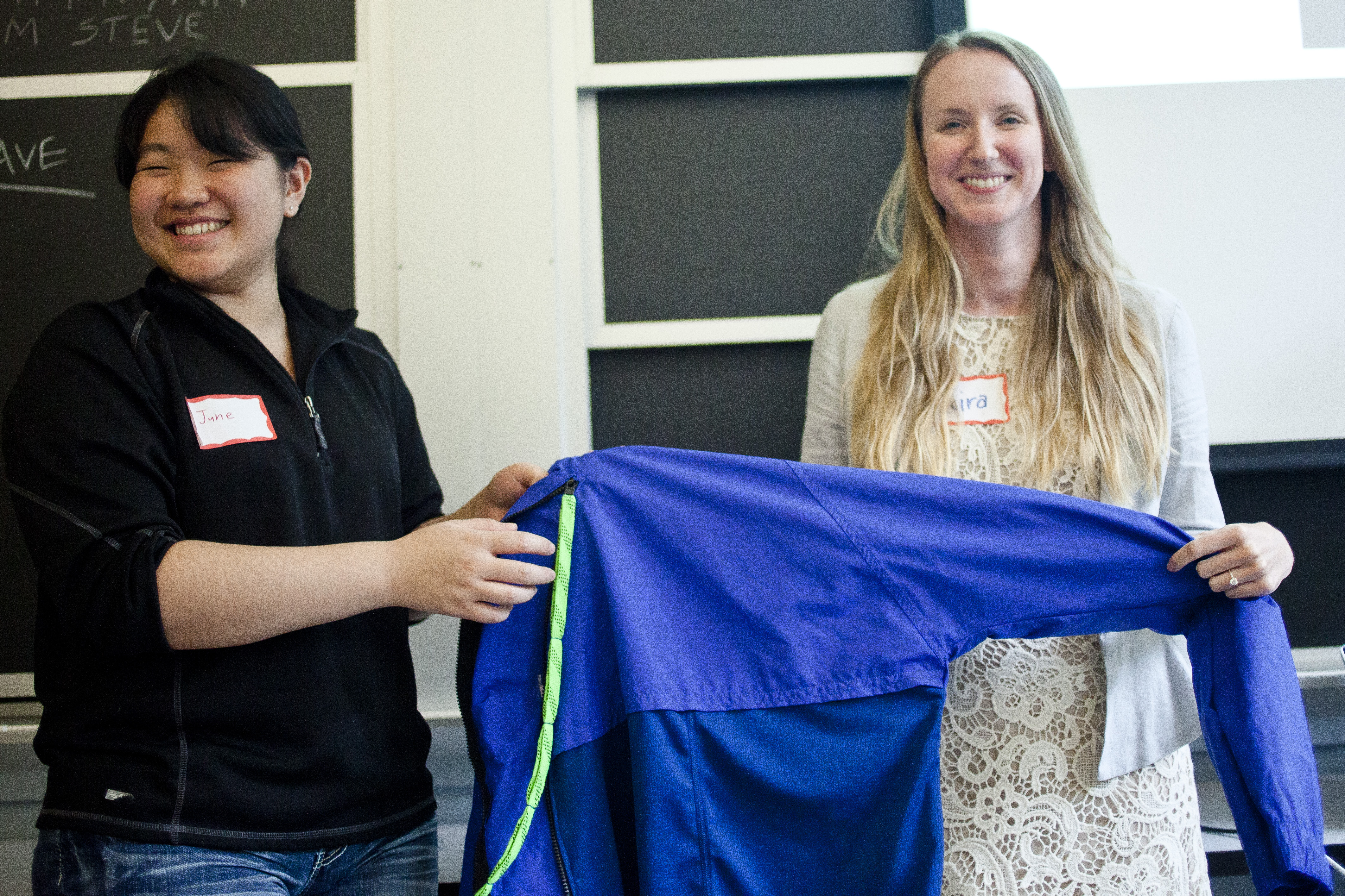 June Kim (left) and Kira Bender presented their prototype “RAYN Jacket,” which they designed with Alexander Peacock (not pictured) specifically for Ryan DeRoche, who sustained injuries in a bicycle accident that make it difficult to get dressed.
