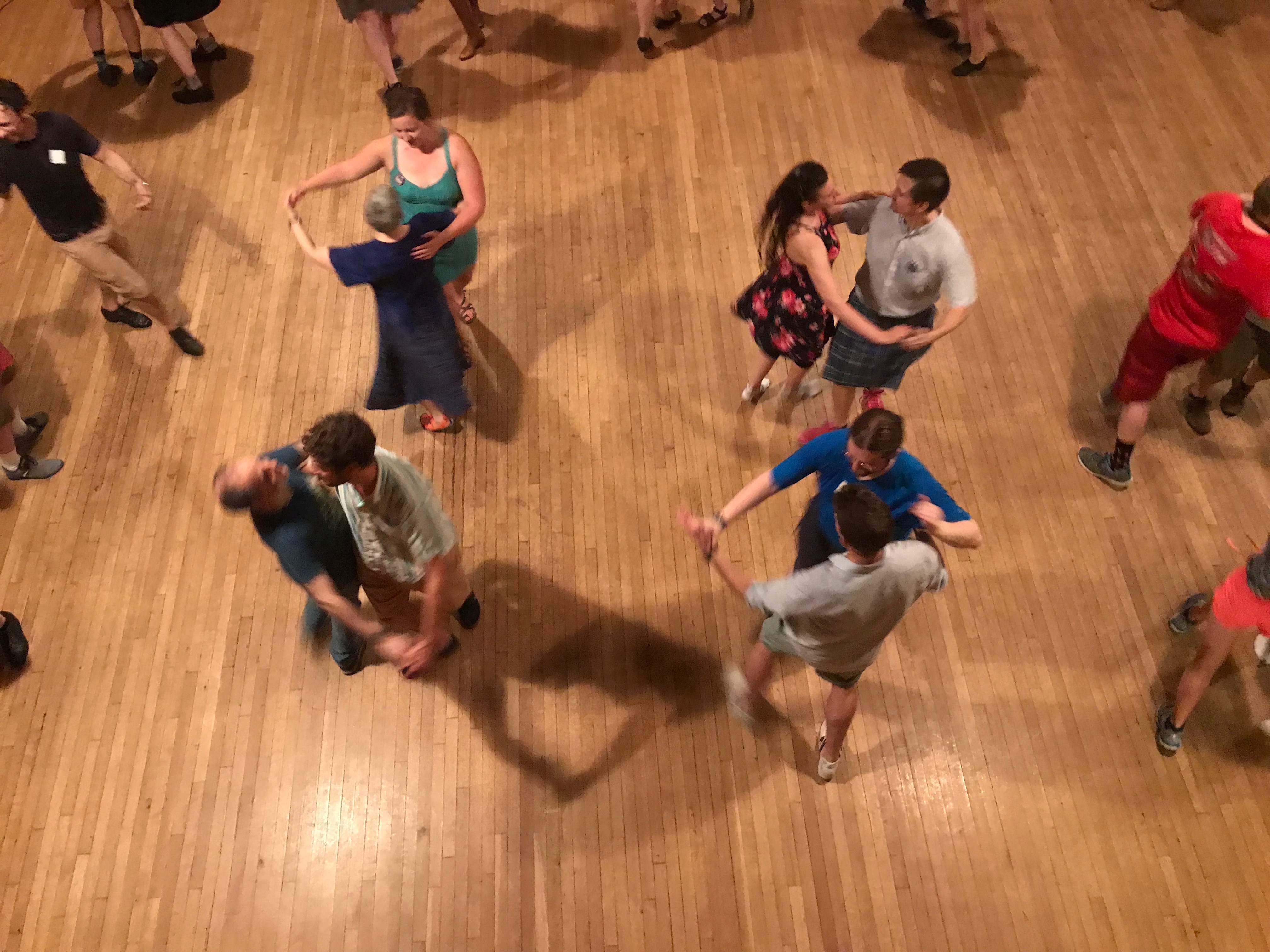 Dancers moved, following the instructions of a caller, as a folk band played.