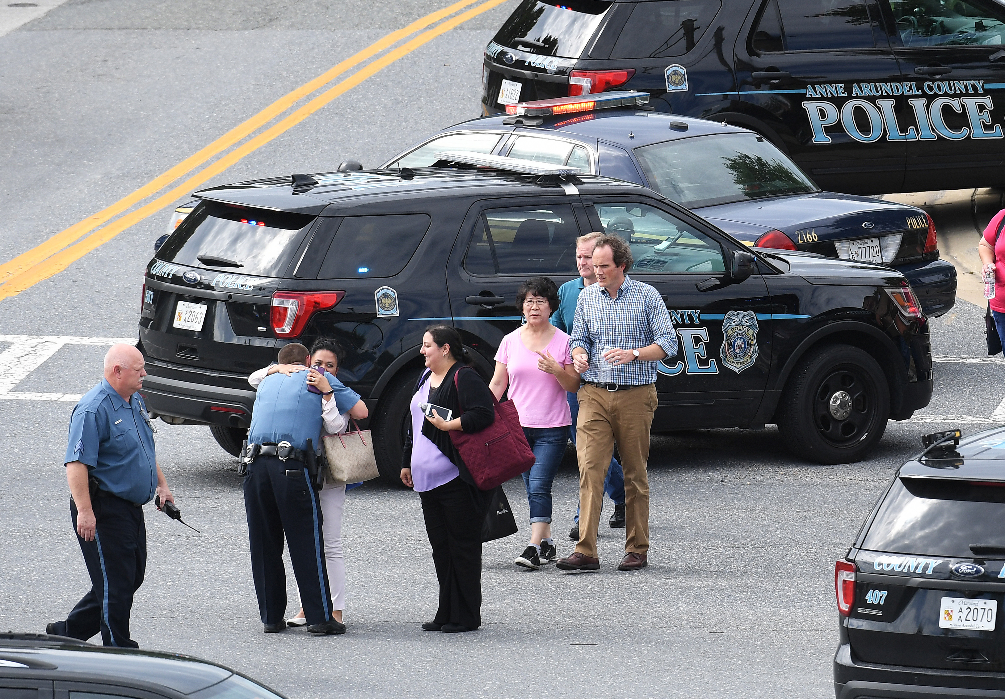 People walked from the direction of the Capital Gazette building, where five people were fatally shot Thursday in Annapolis, Maryland.