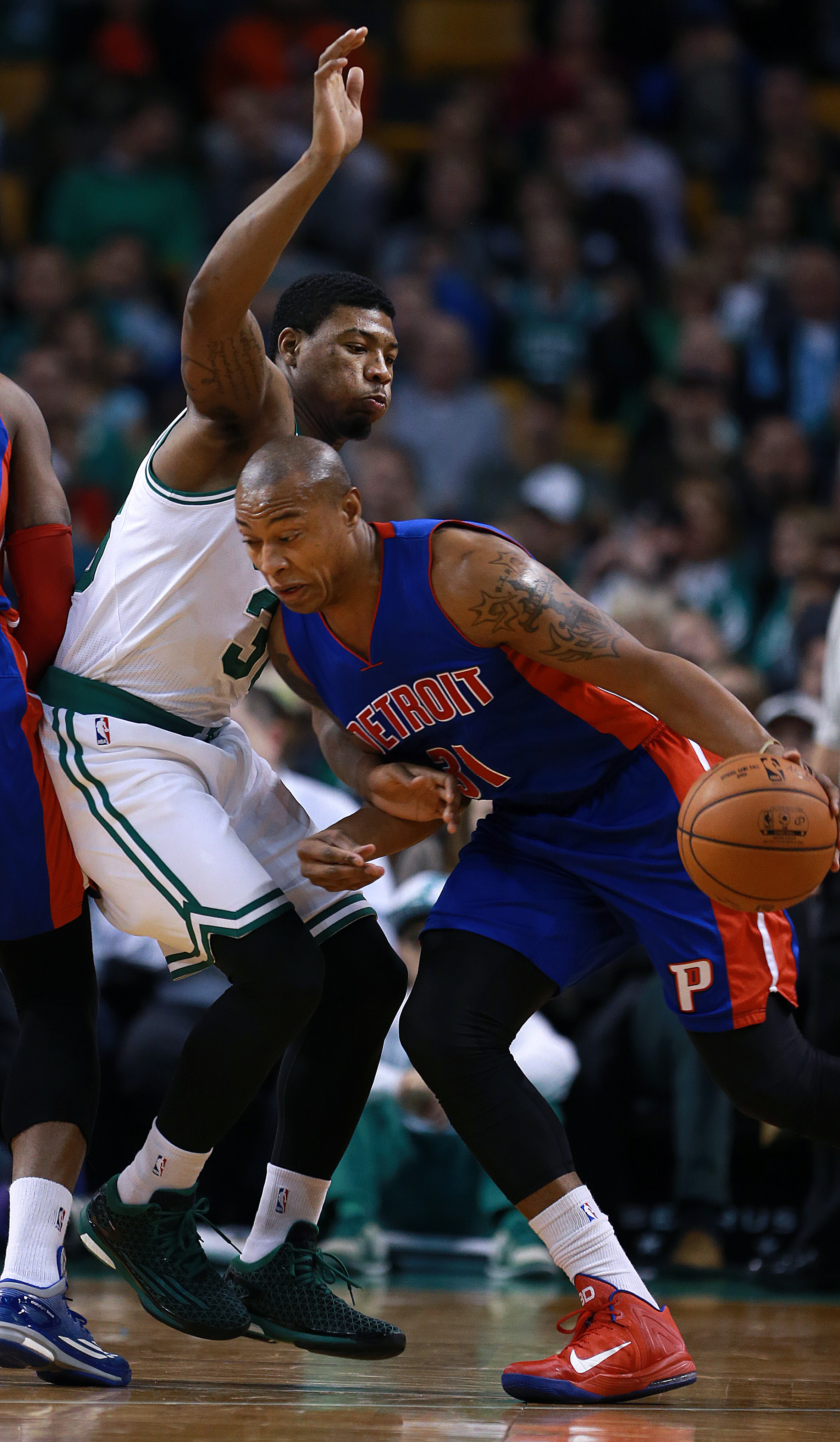 Marcus Smart, in his first game back after an ankle injury, defends the Pistons’ Caron Butler in the first half.