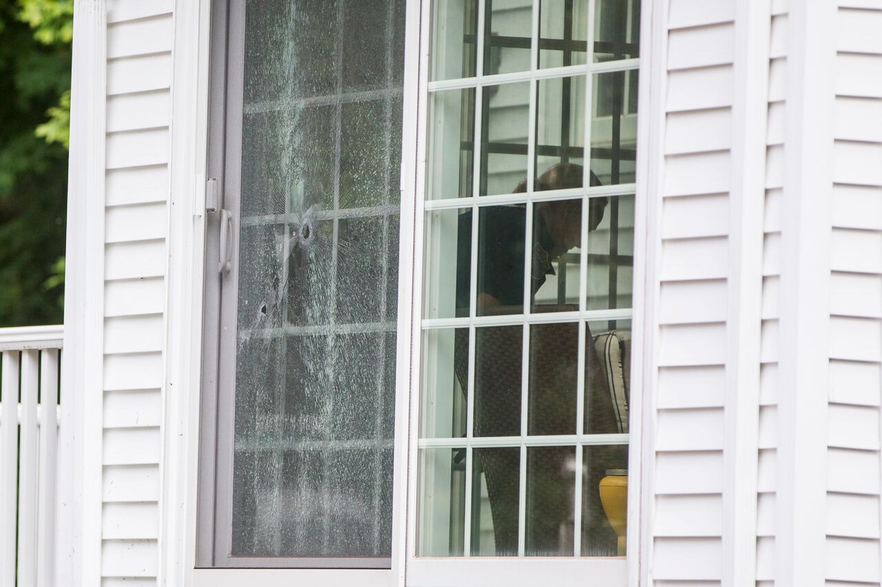 Bullet holes could be seen in the sliding glass door of a nearby home.