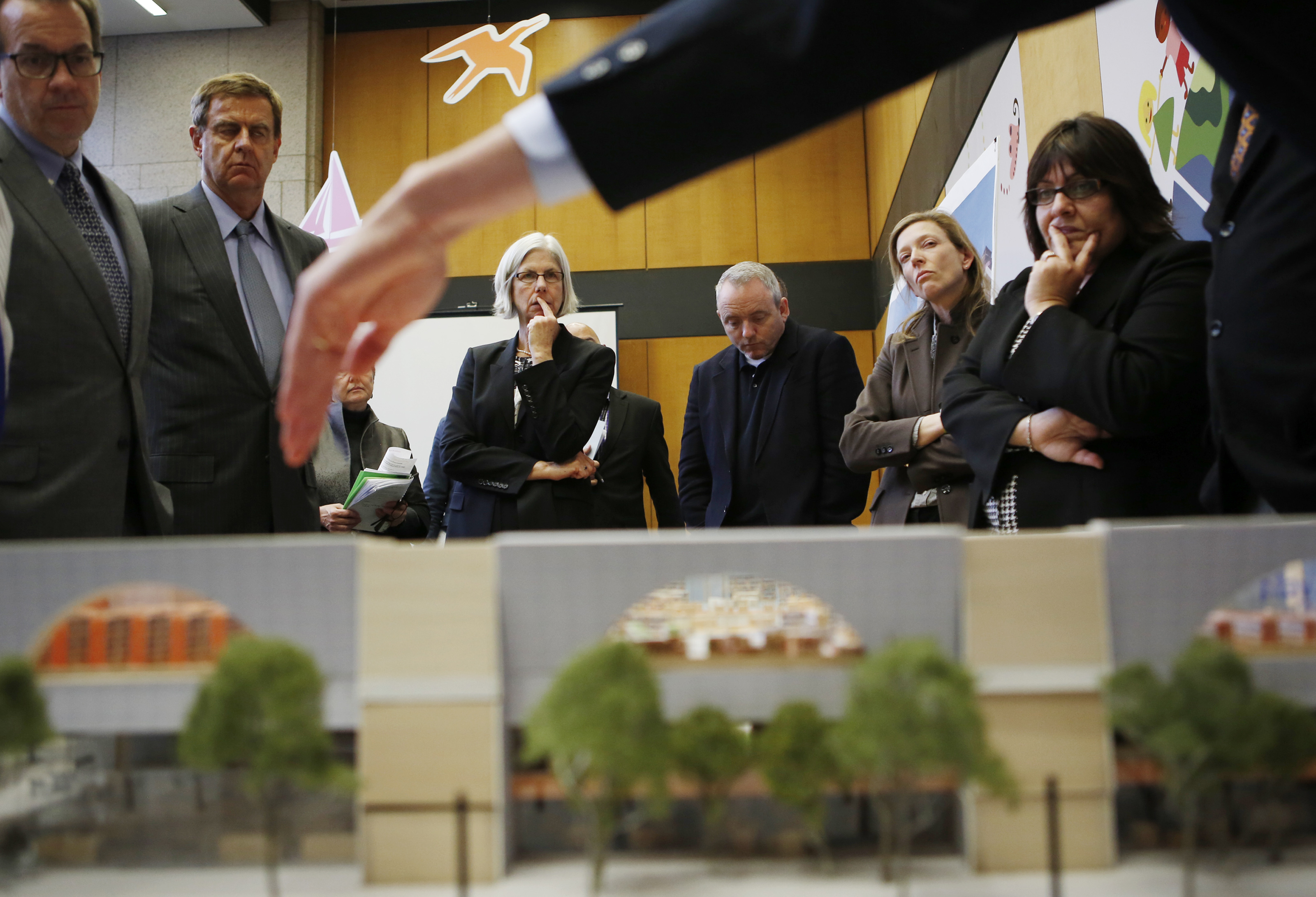 Architect Clifford Gayley (his hand in foreground) points to parts of the renovation in a meeting with Boston Public Library trustees and board members.