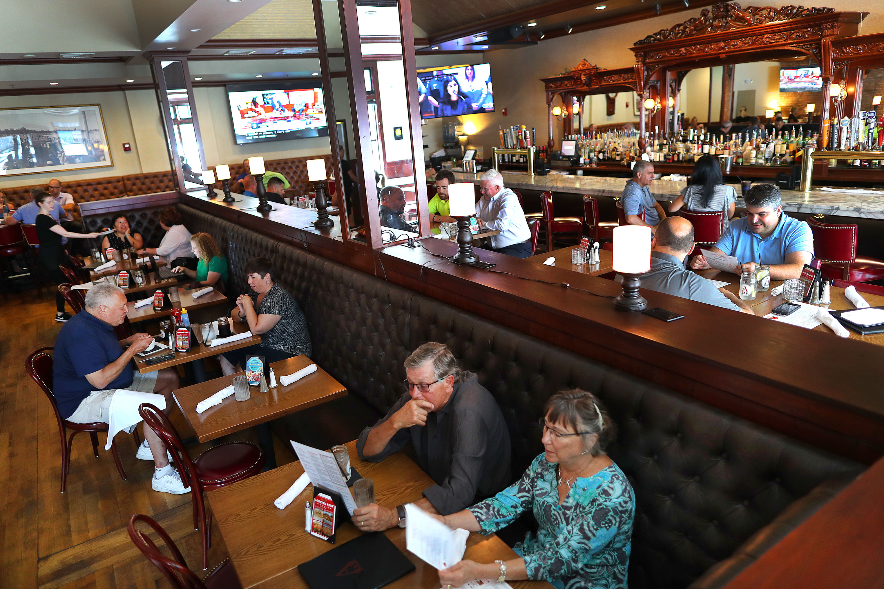 Bill Zucker and Jan Geddes (bottom) looked over the menu in the dining room.
