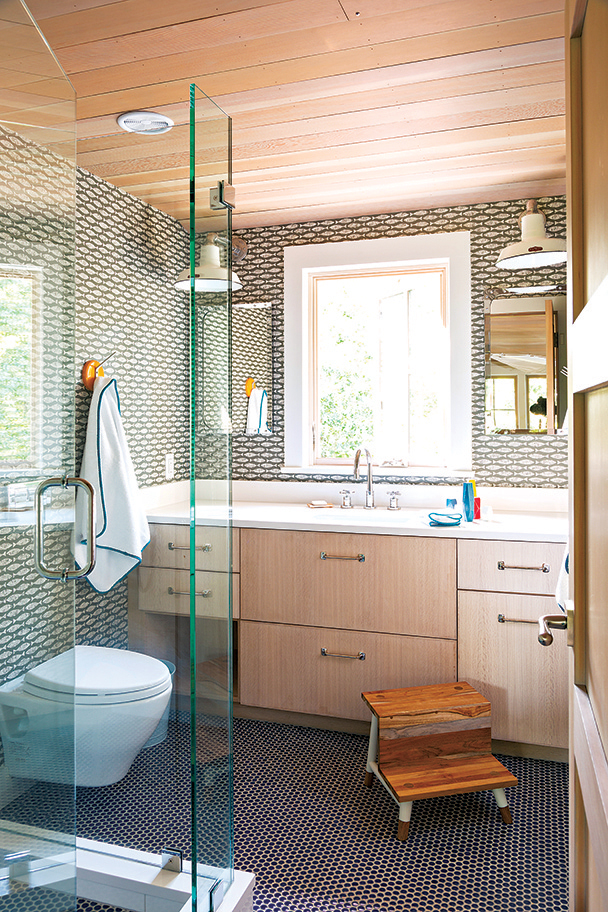 The expanded kids’ bathroom has a custom vanity and penny tile on the floor.