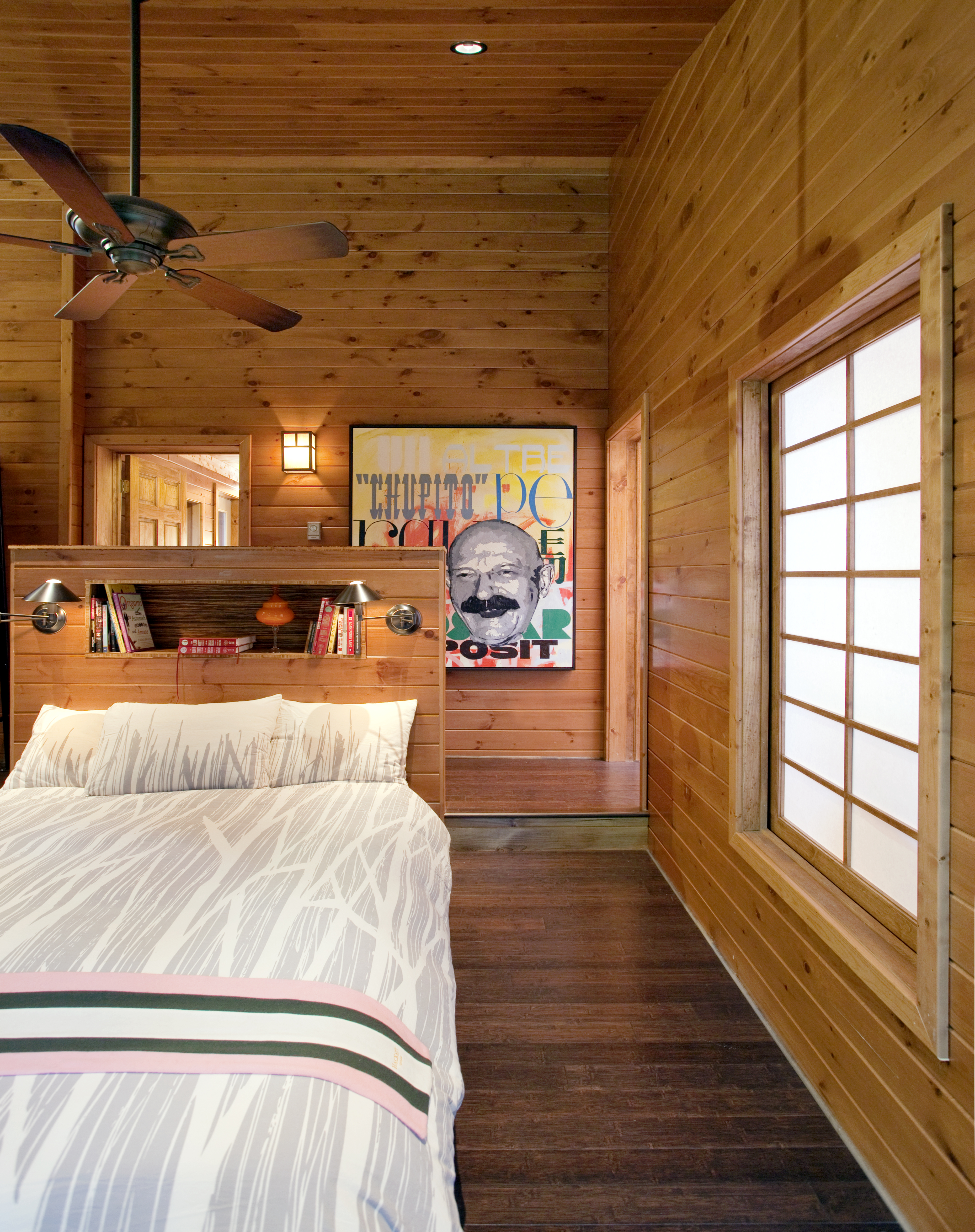 <b>THE BIG WOODS</b> The cabin sits on 69 acres, most of it conservation land; an attached garage was converted into a high-ceilinged master bedroom, which a ceiling fan cools in summer.