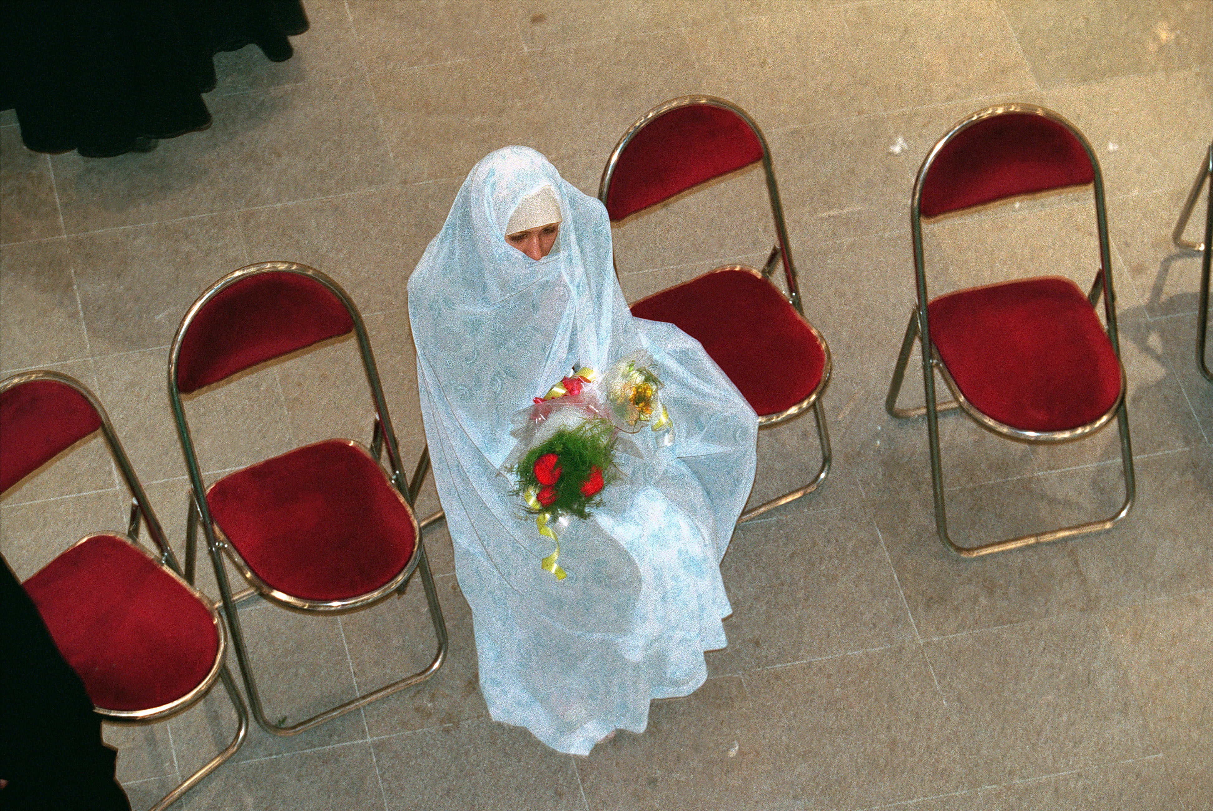 In Iran, a bride waits for her groom at a 2001 wedding.