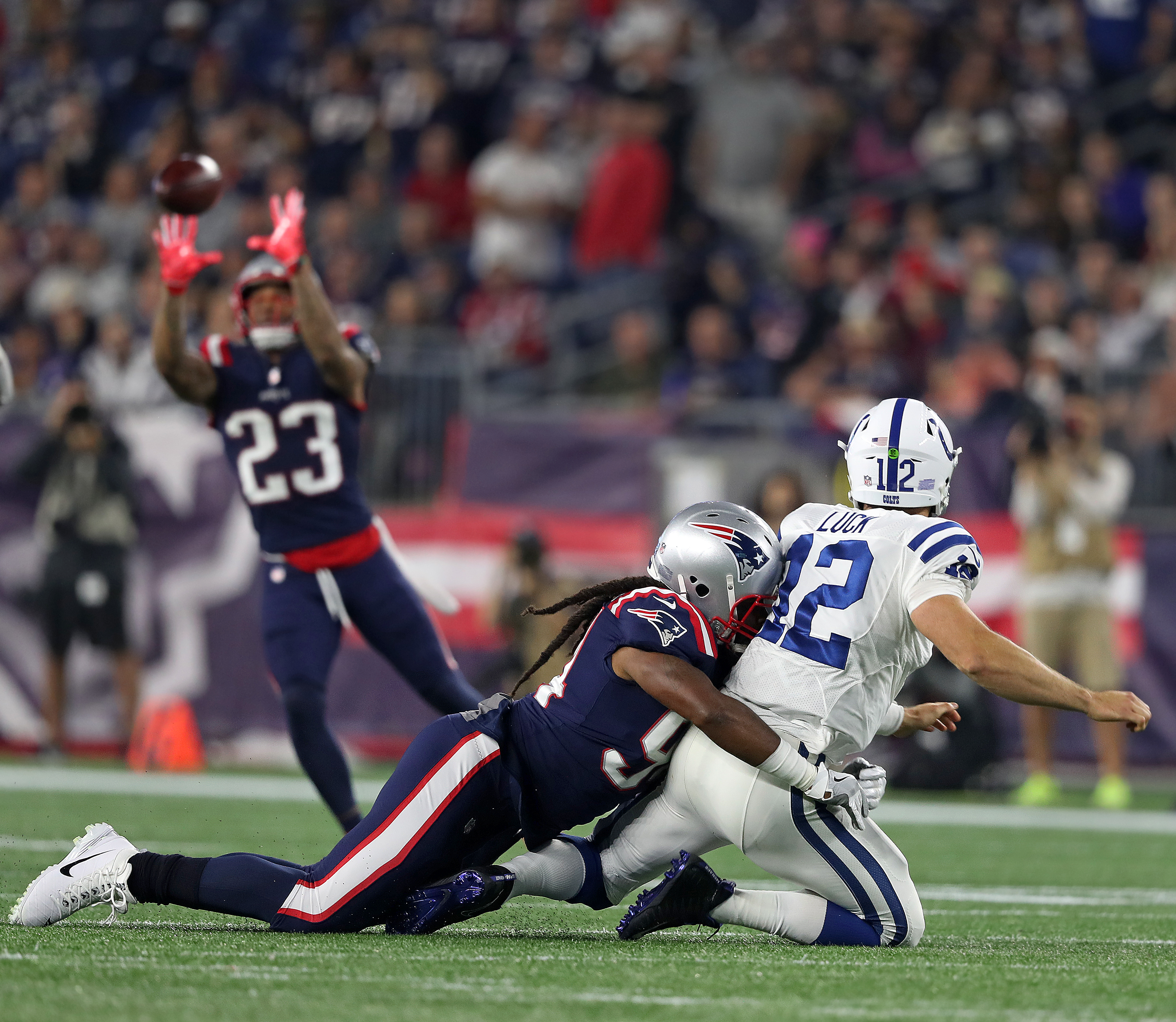 Adrian Clayborn hits Andrew Luck, forcing an errant pass that was intercepted by Patrick Chung (23) late in the second quarter.