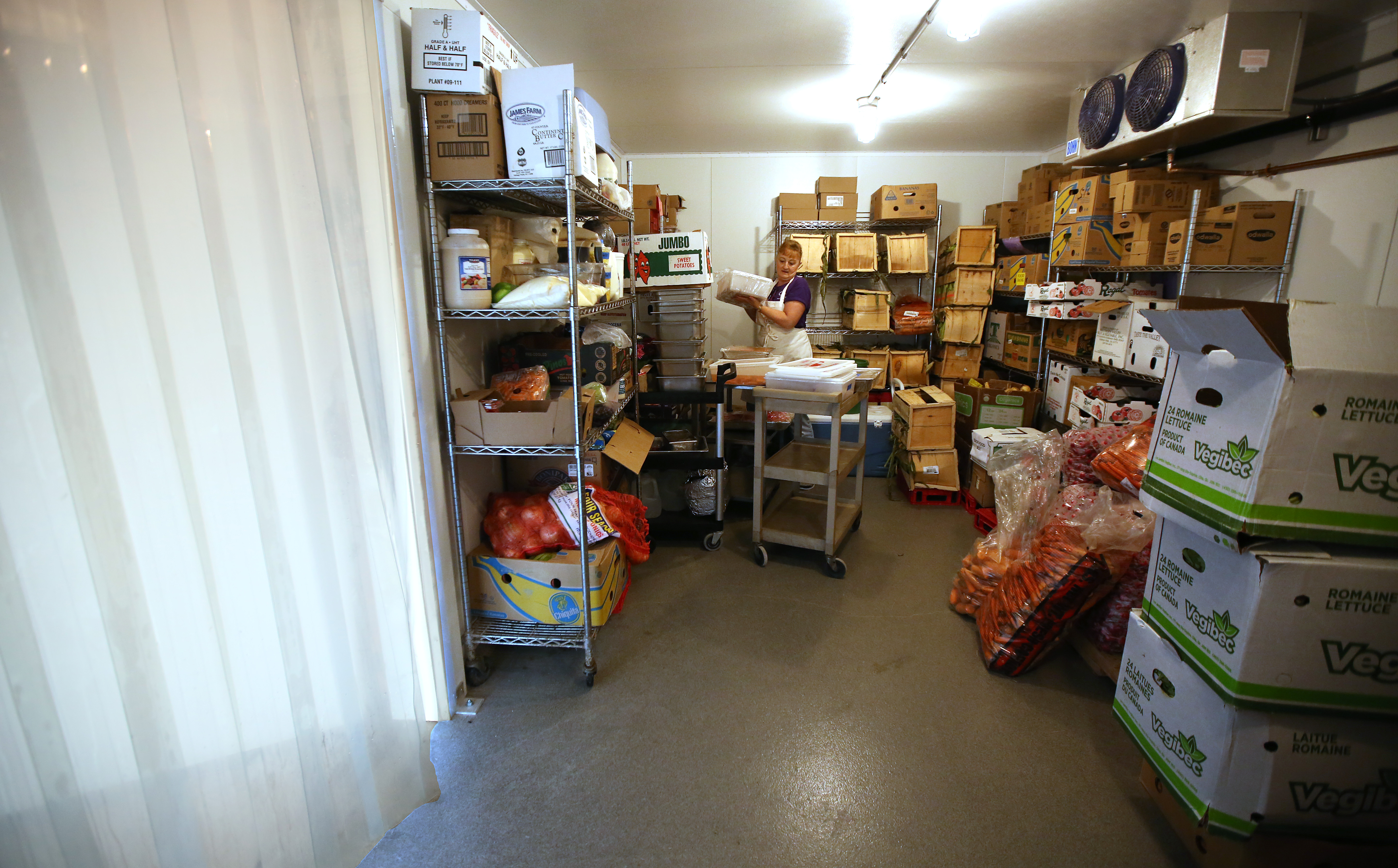 Kitchen assistant Lauralee Taylor stored prepped foods in the cooler for the Summer Meals program.