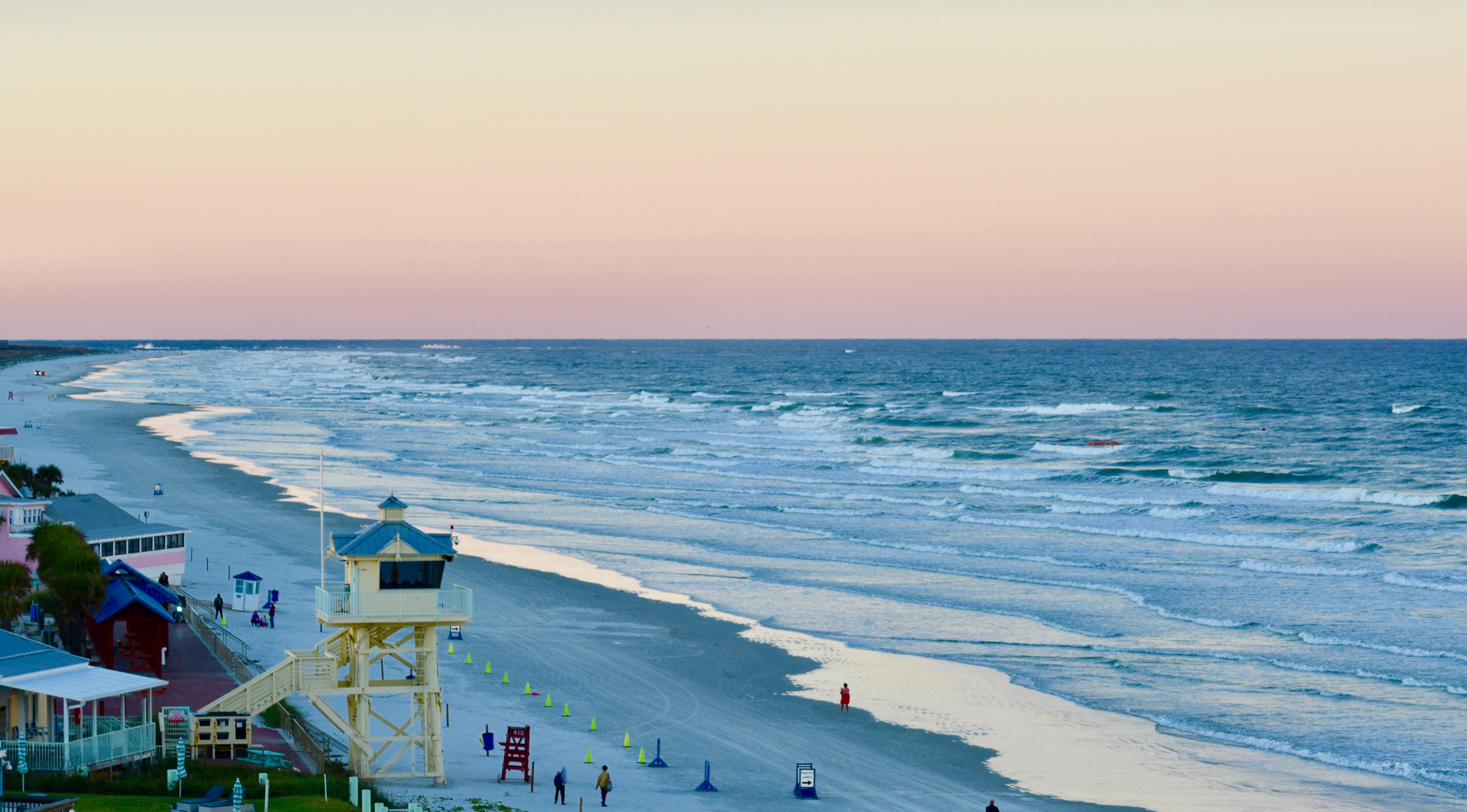 Beach walkers enjoy the sunset in New Smyrna Beach.