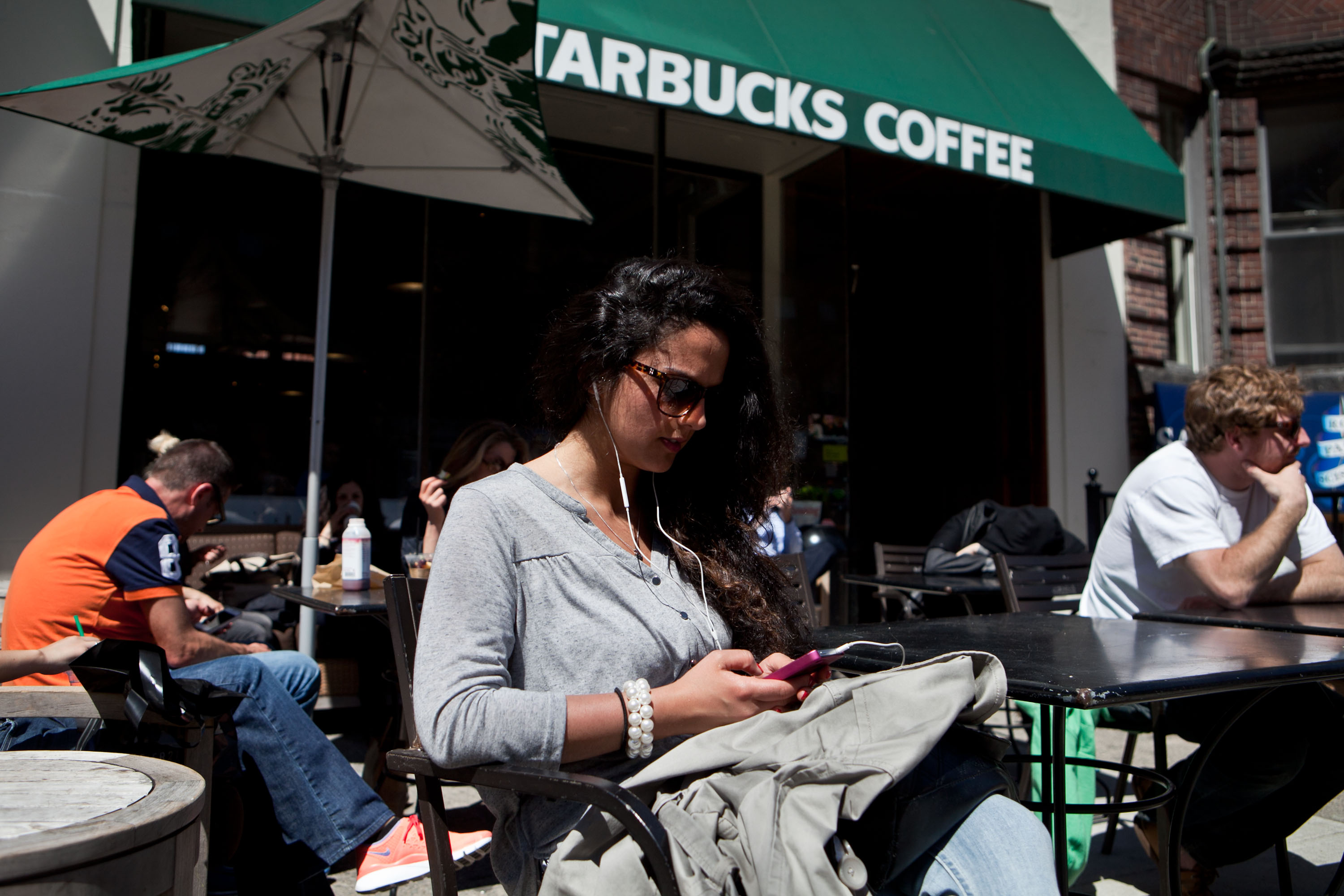 Shermine Kaschani relaxed at the Starbucks Coffee on Newbury Street as it again welcomed customers Wednesday.