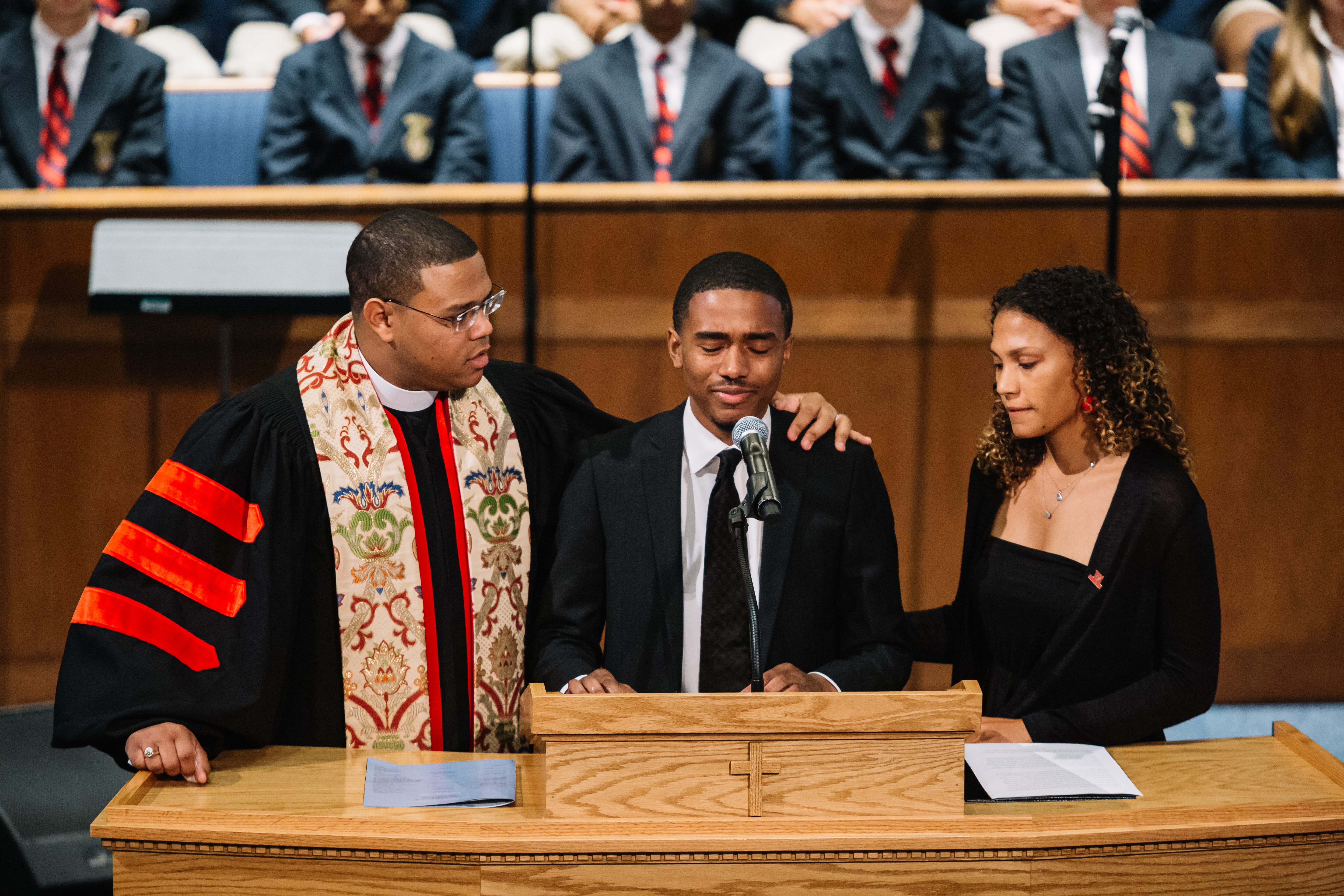 BU student Derrick Lottie Jr. was comforted by the pastor, Kevin Murriel, as he and Maya Foreman spoke about their friend Erin Edwards during the service at Cascade United Methodist Church.