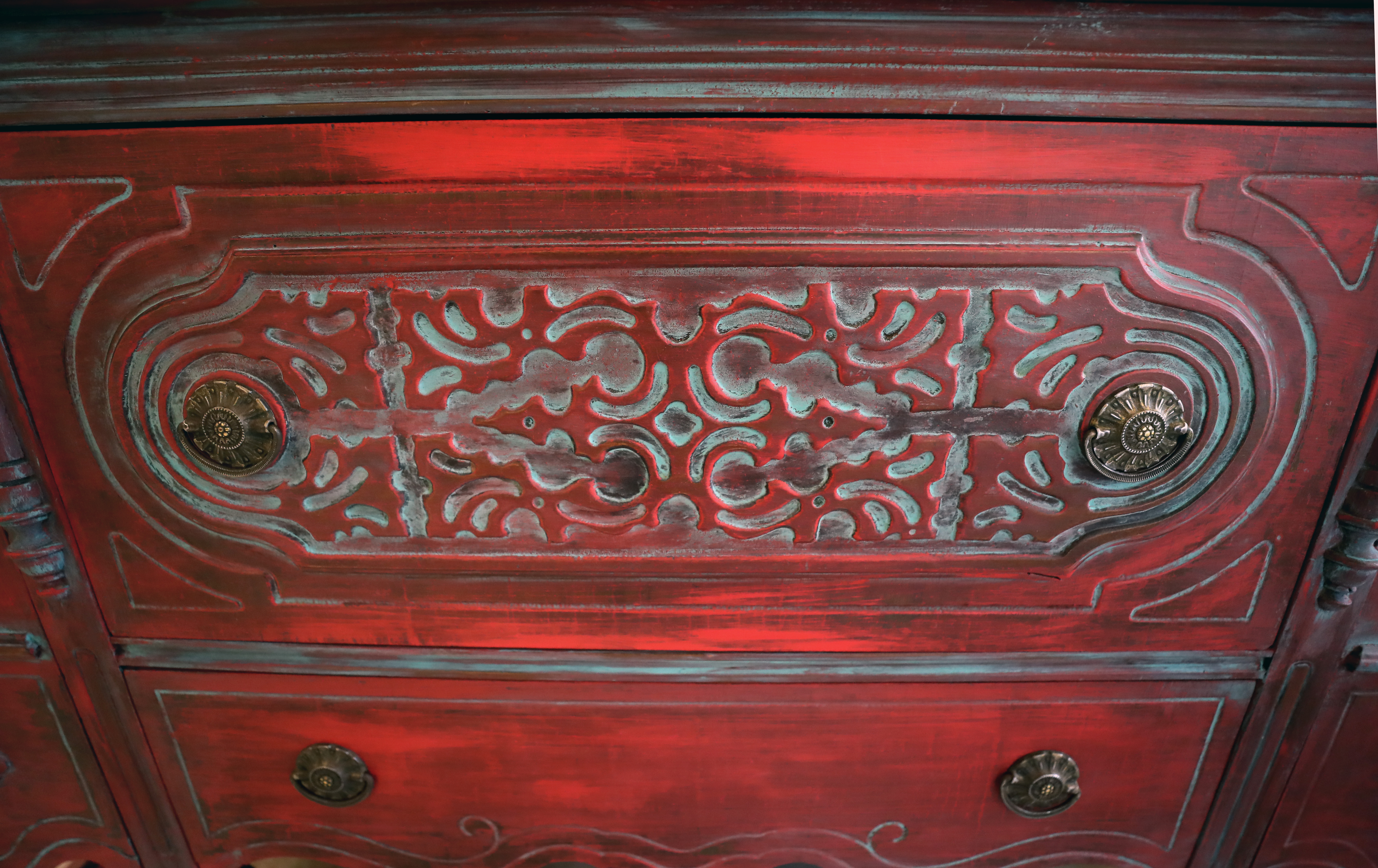 And have fun with color! Here, an antique cabinet has been stained red to show off the detailed woodwork.