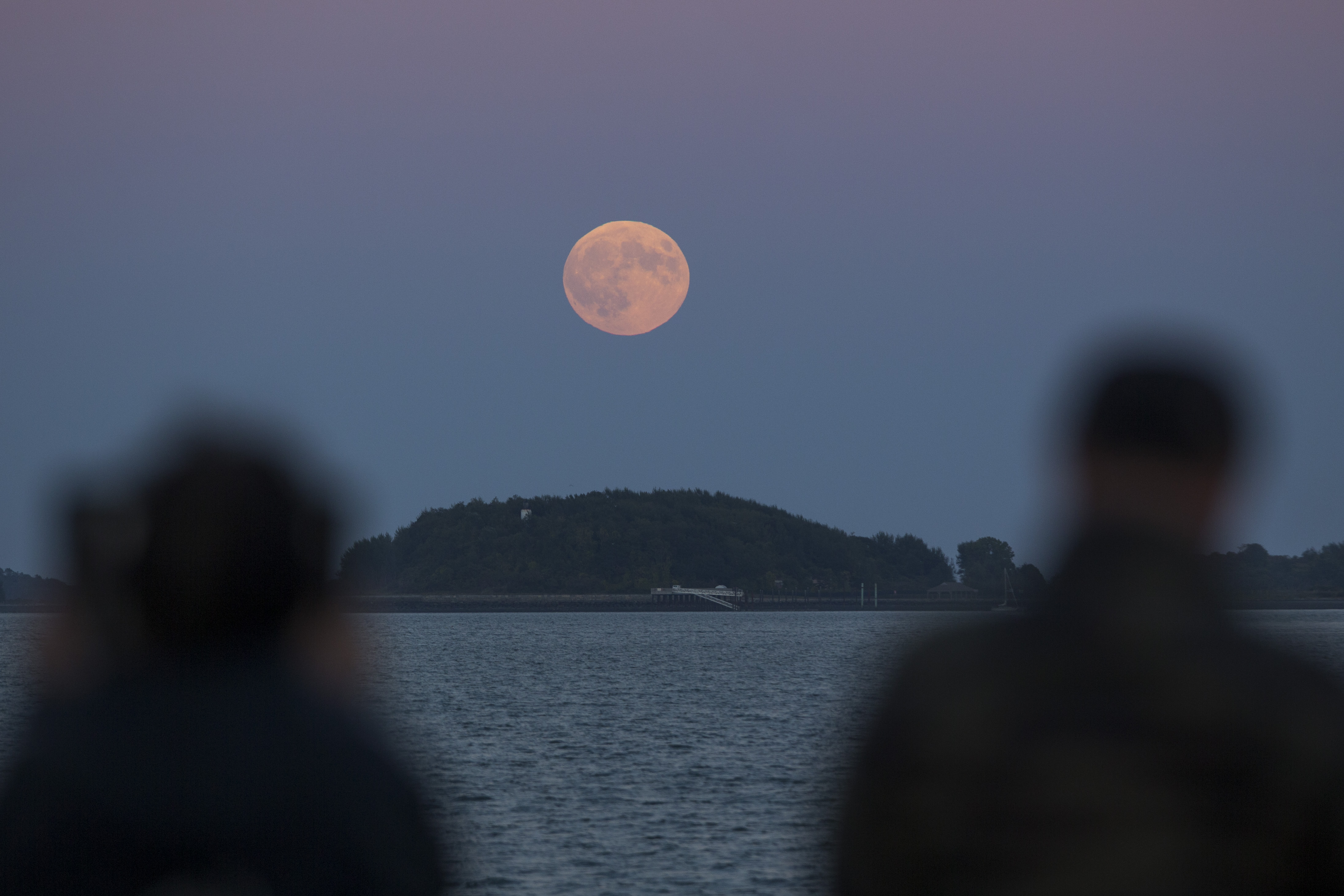 Spectators viewed the supermoon on Boston’s Castle Island.