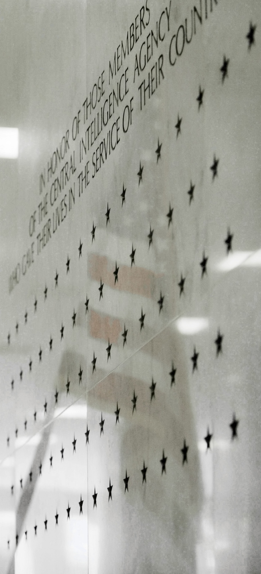 In this file photo, the American flag is reflected off of a marble slab of the CIA memorial wall containing stars in the lobby of the Central Intelligence Agency headquarters in Langley, Va.