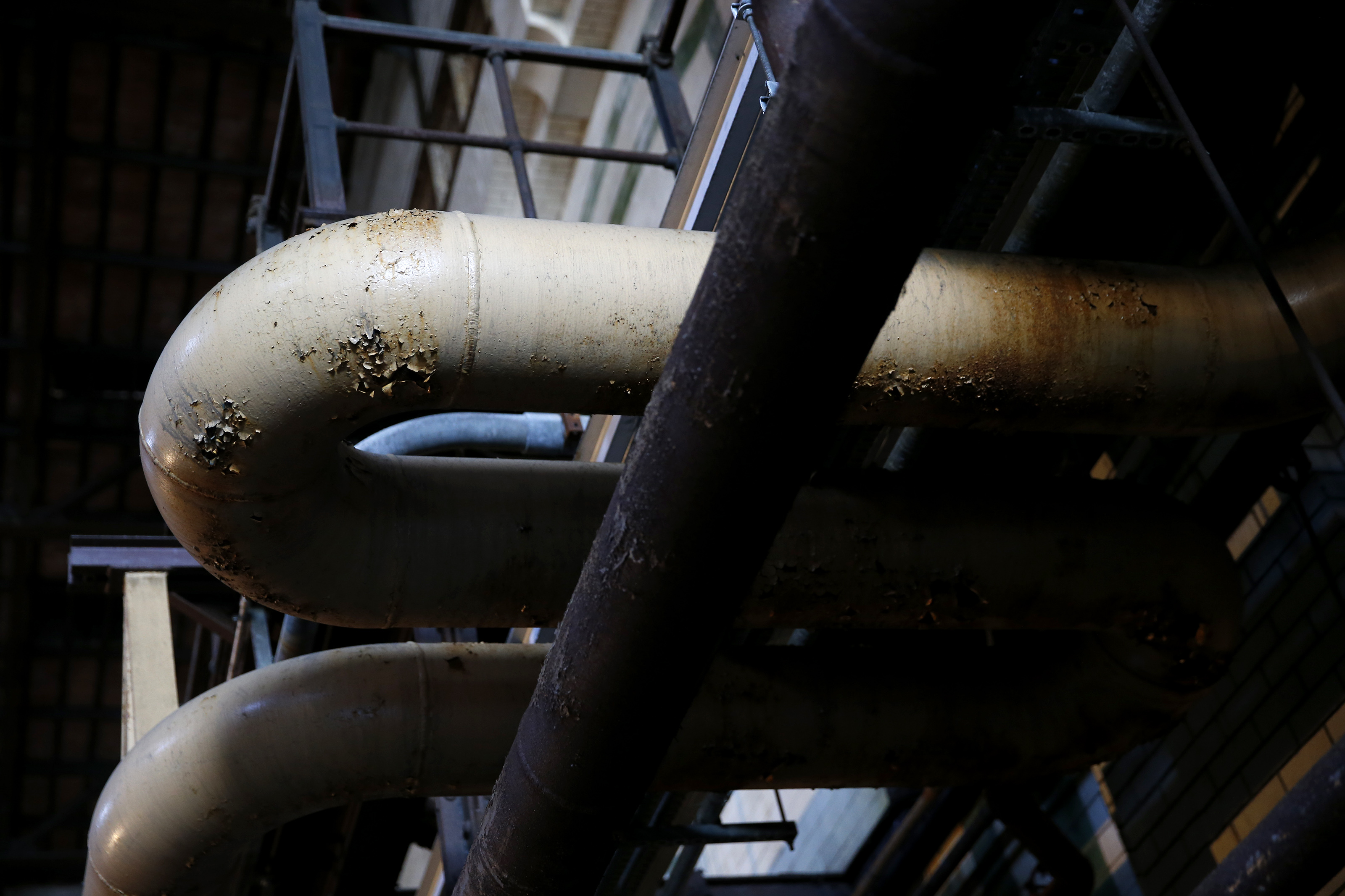 Exposed pipes cut a figurative shape inside of the L Street Power Station.