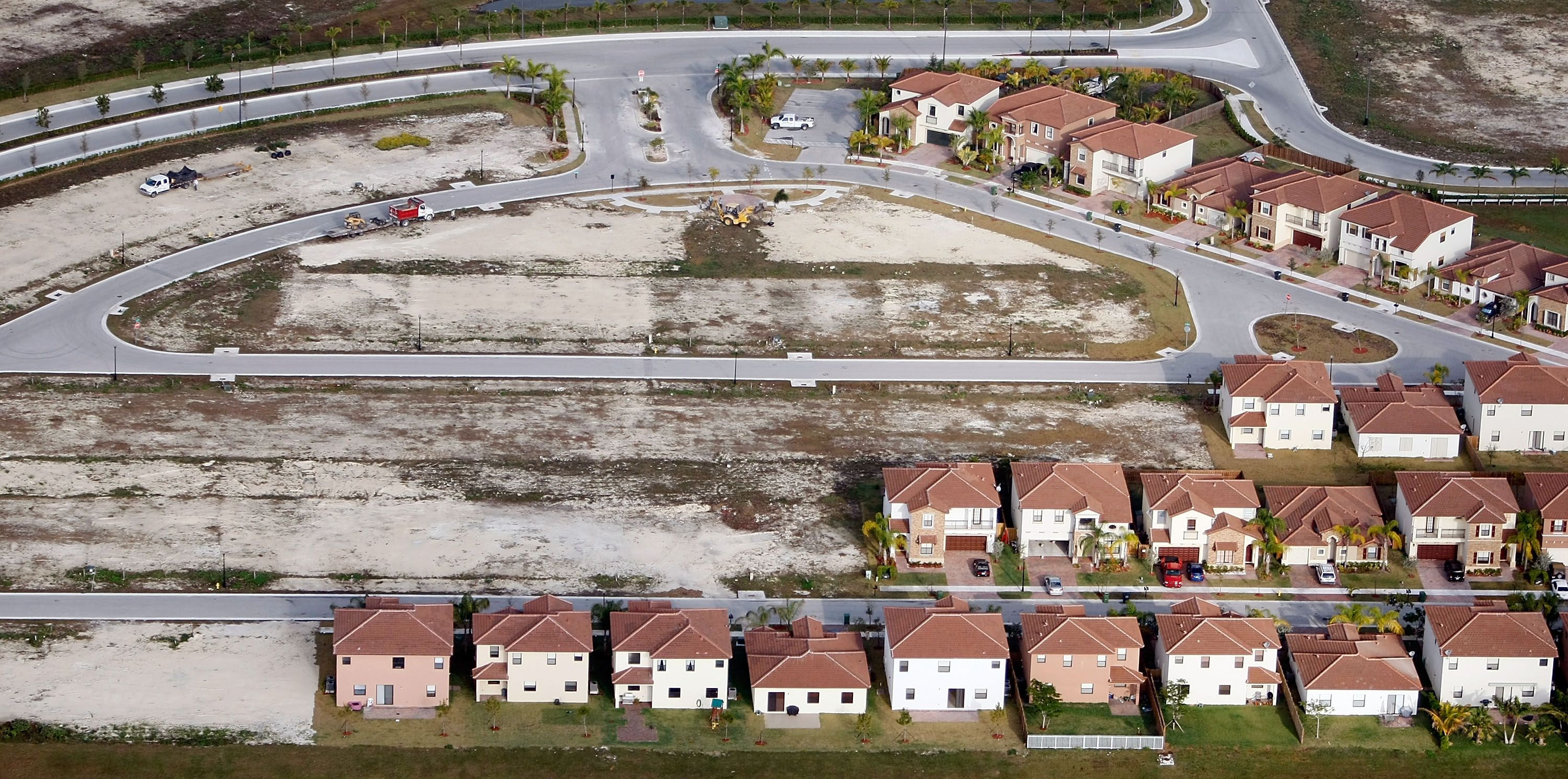 Empty lots sat next to newly constructed homes in a Homestead, Fla., subdivision in 2009. In 2011, the US Financial Crisis Inquiry Commission report pointed to the housing bubble and “widespread failures in financial regulation” as the cause of the nationwide fiscal crisis.