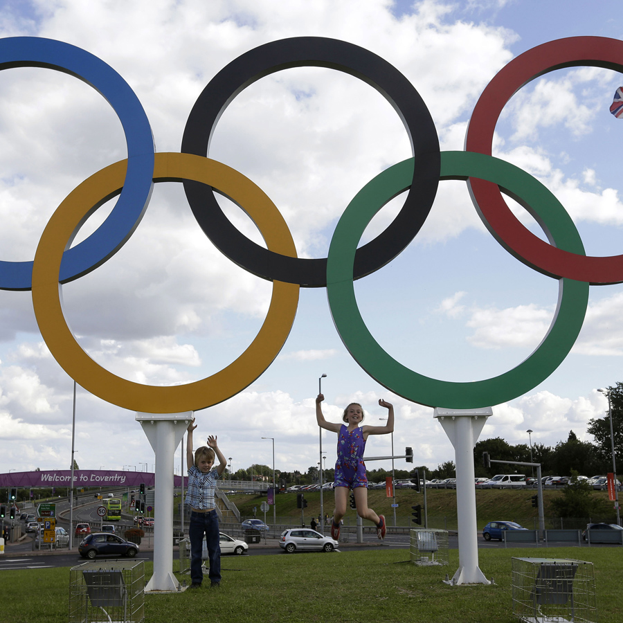 Children posed under a sculpture of the Olympic rings in Coventry, England, in July 2012. London was the host city for the most recent Summer Games.