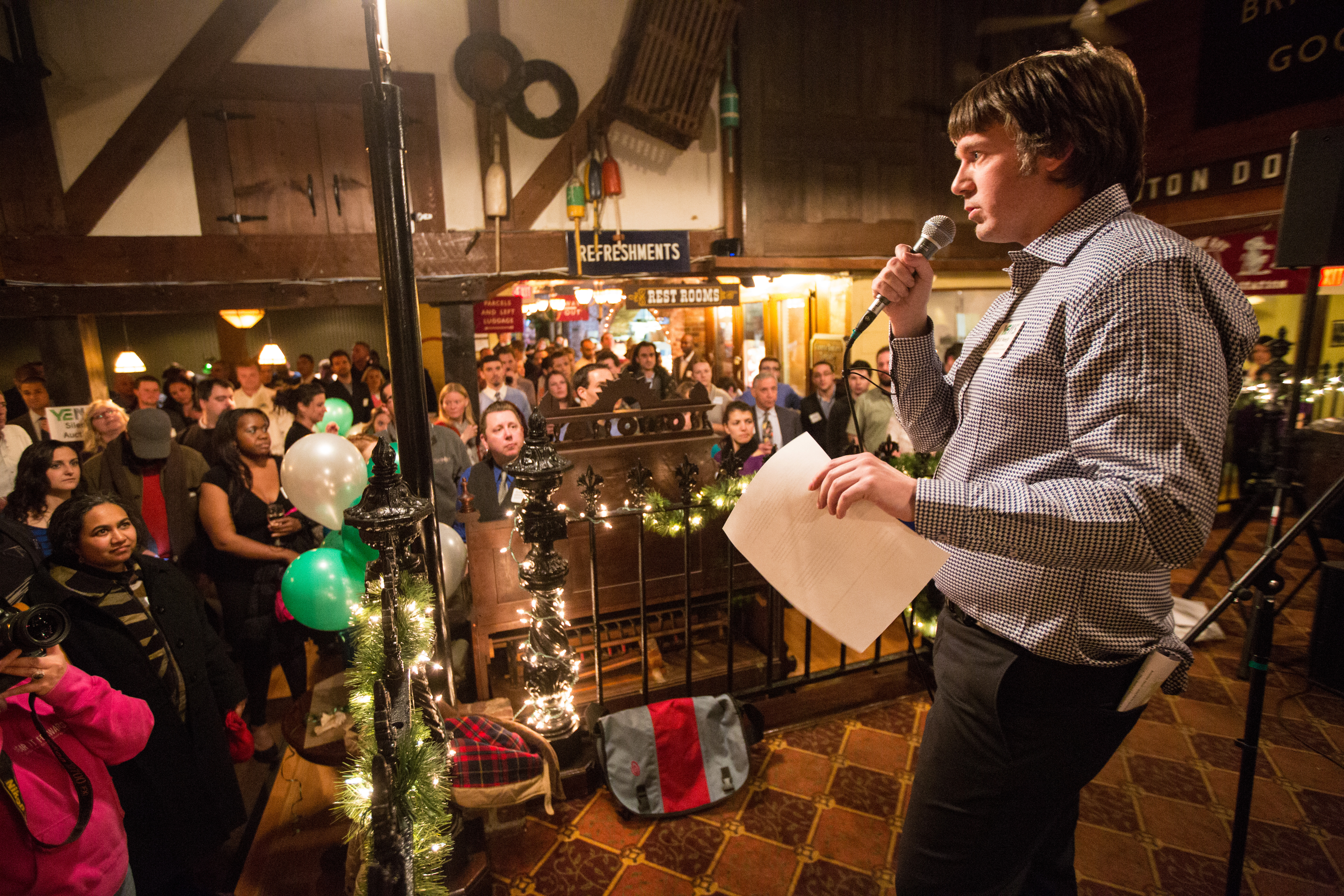 Will Neely, 30, Programs and Operations Manager at Enterprise Center, addresses the crowd during a Young Entrepreneurs of the North Shore event held at Victoria Station in Salem.