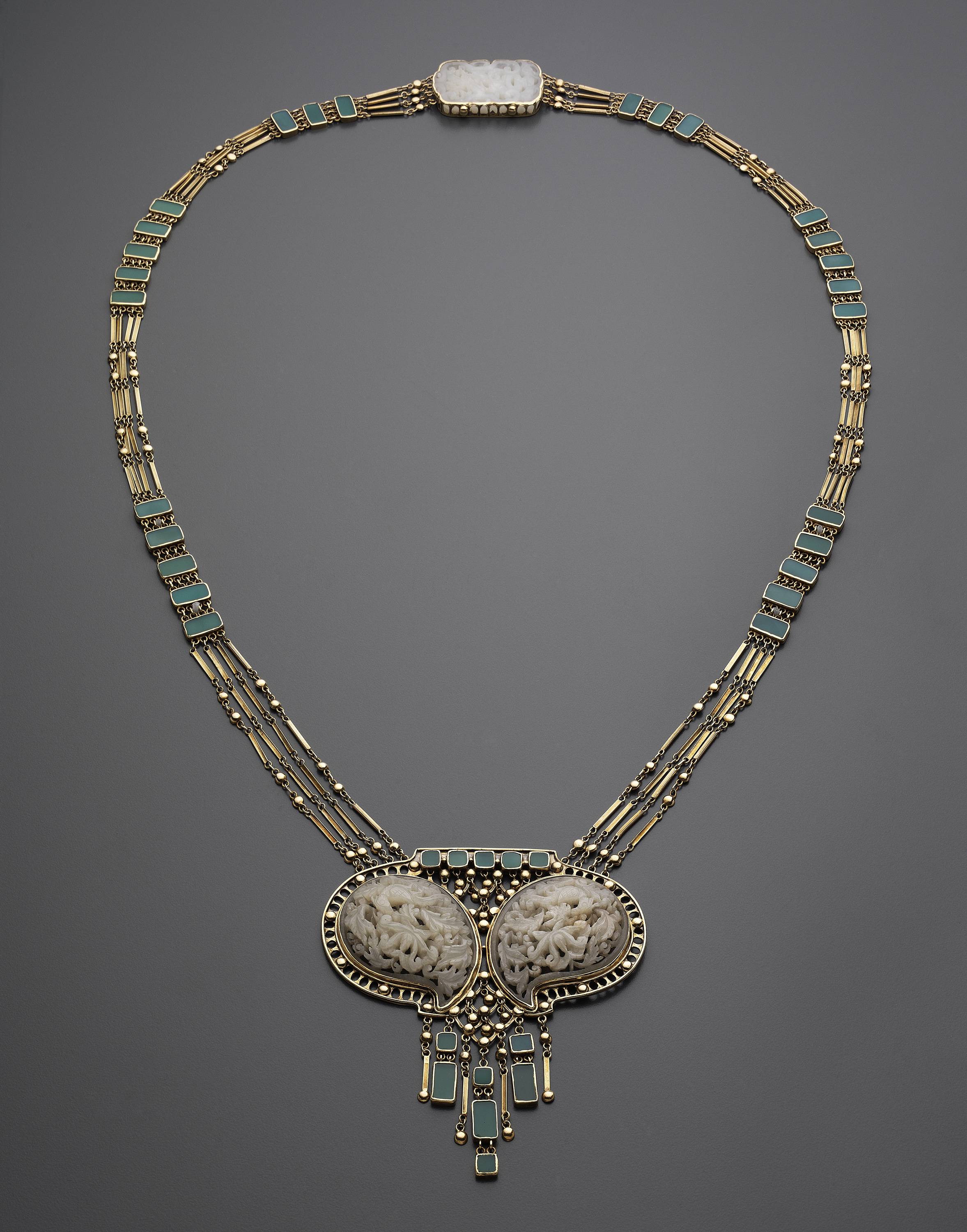 A gold, jade, and colored glass necklace by Josephine Hartwell Shaw, displayed in "Boston Made: Arts and Crafts Jewelry and Metalwork" at the Museum of Fine Arts.