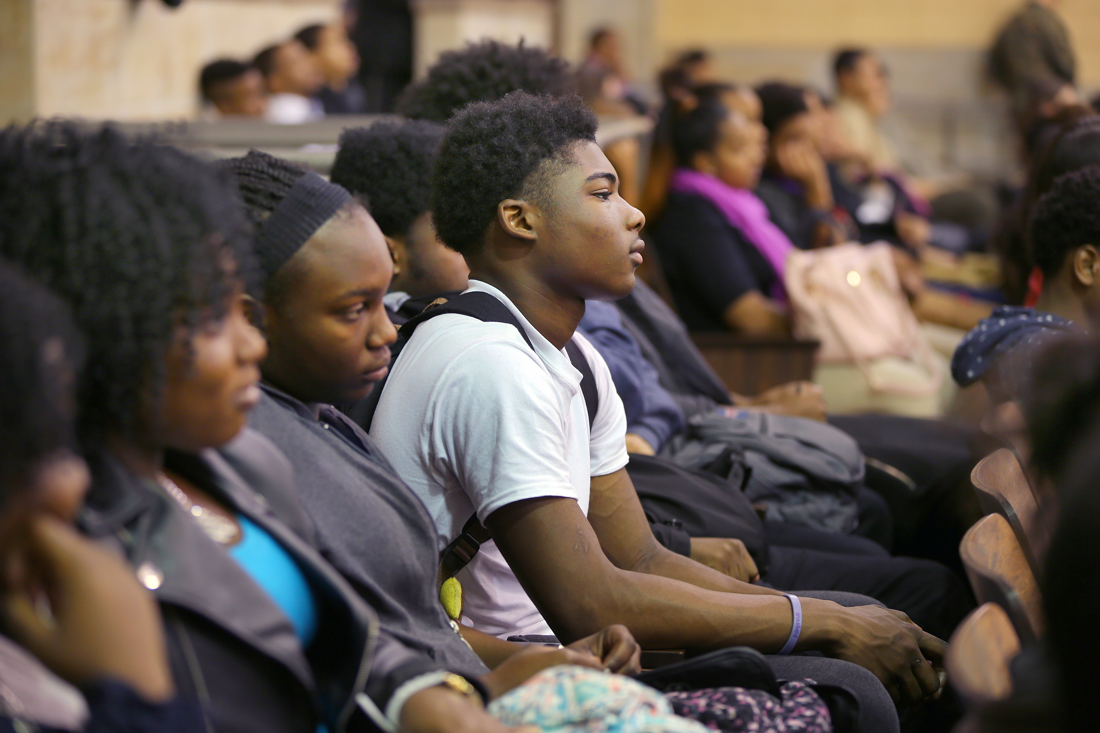Students listened to him speak in the auditorium.