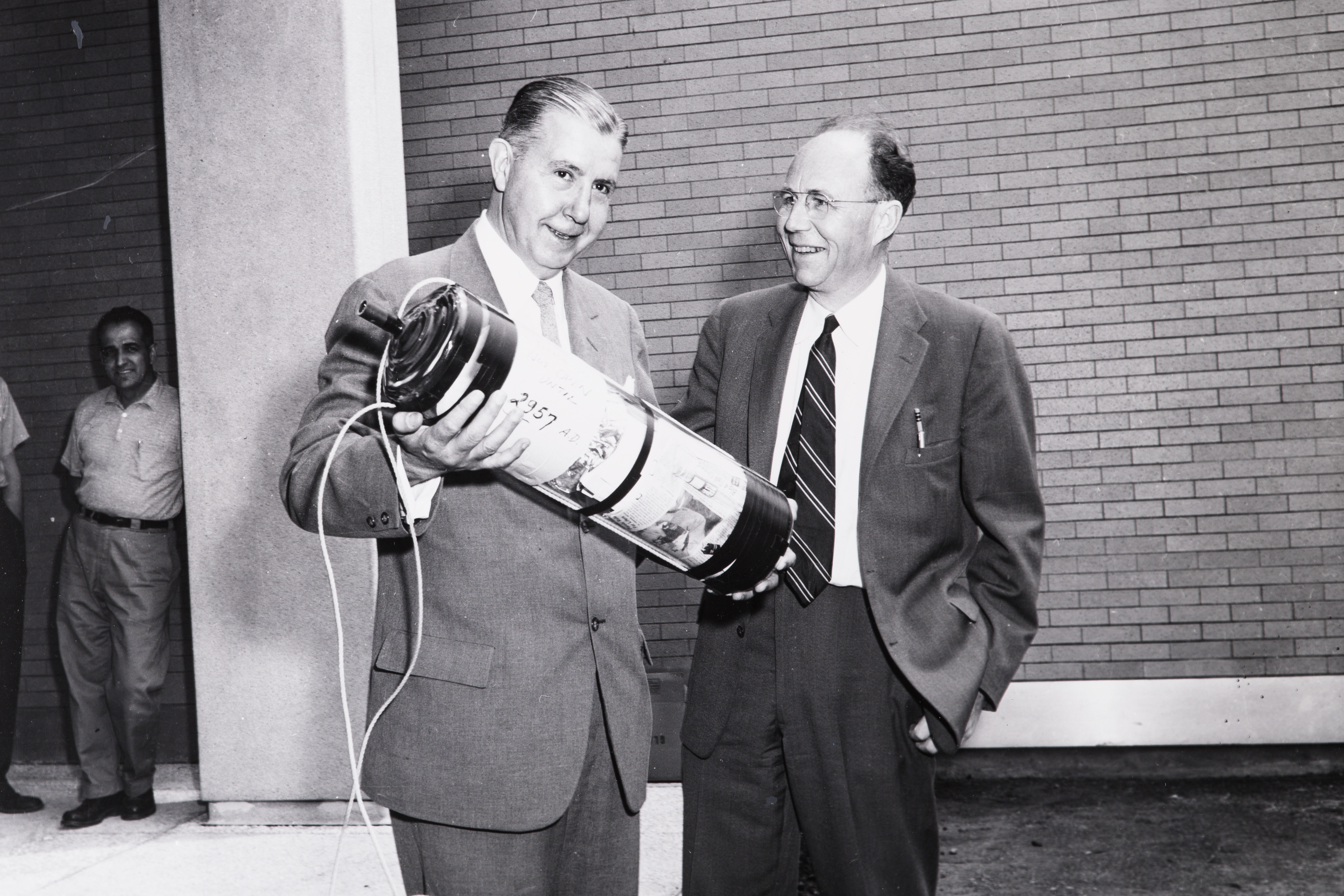 A 1957 photograph shows president James R. Killian Jr. and electrical engineering professor Harold “Doc” Edgerton with the capsule.