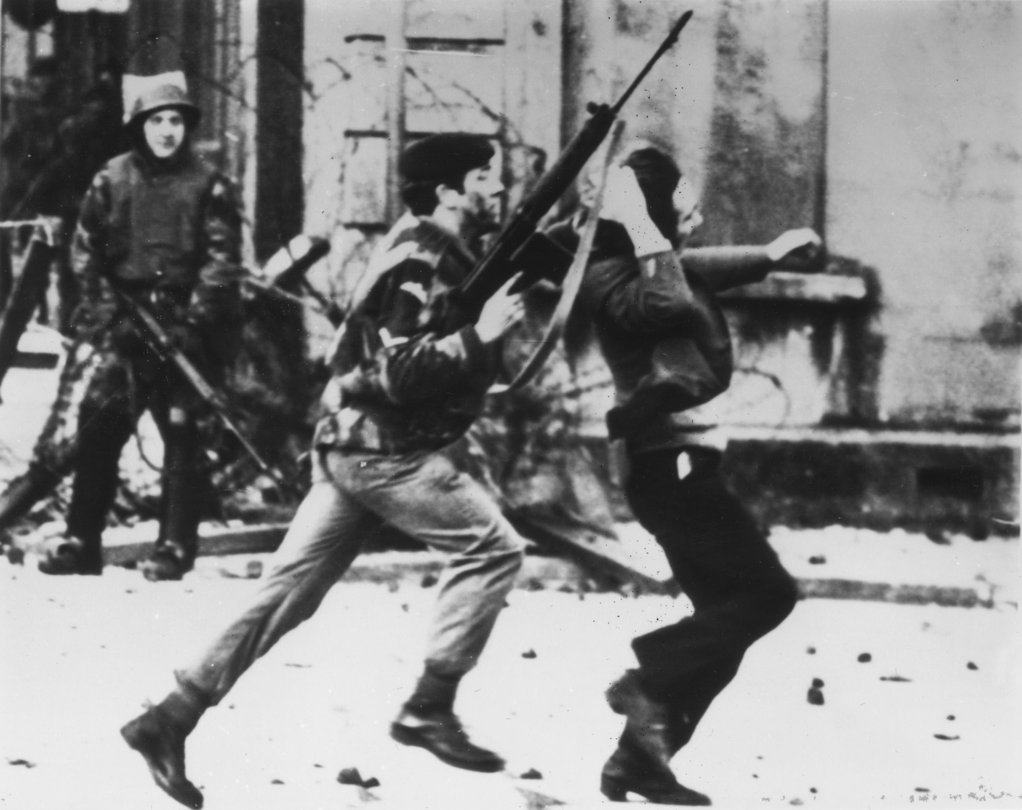 An armed soldier attacks a protester on Bloody Sunday.