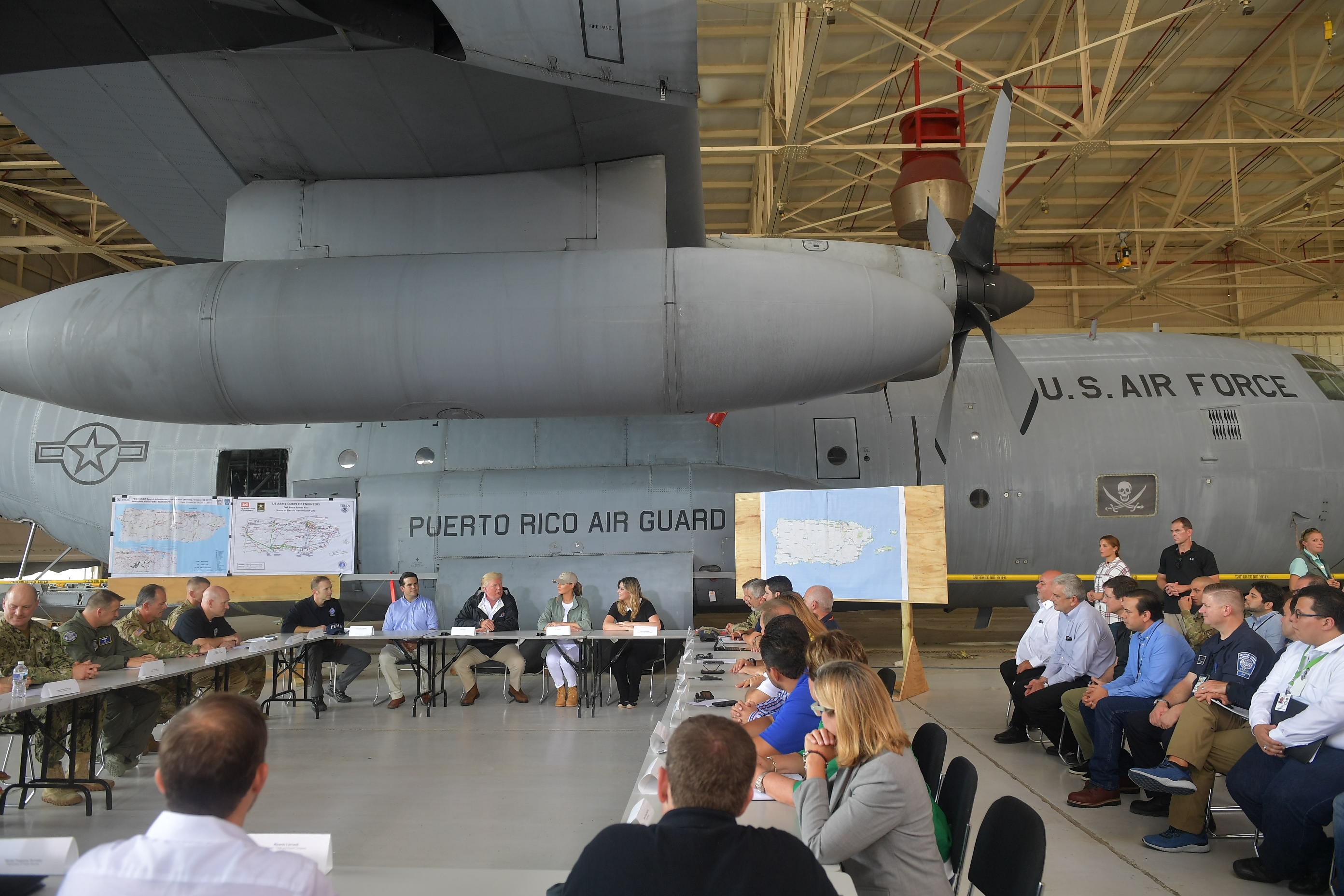 President Donald Trump and First Lady Melania Trump attended a meeting with officials after stepping off Air Force One upon arrival at Luis Muñiz Air National Guard Base in Carolina, Puerto Rico on Tuesday.