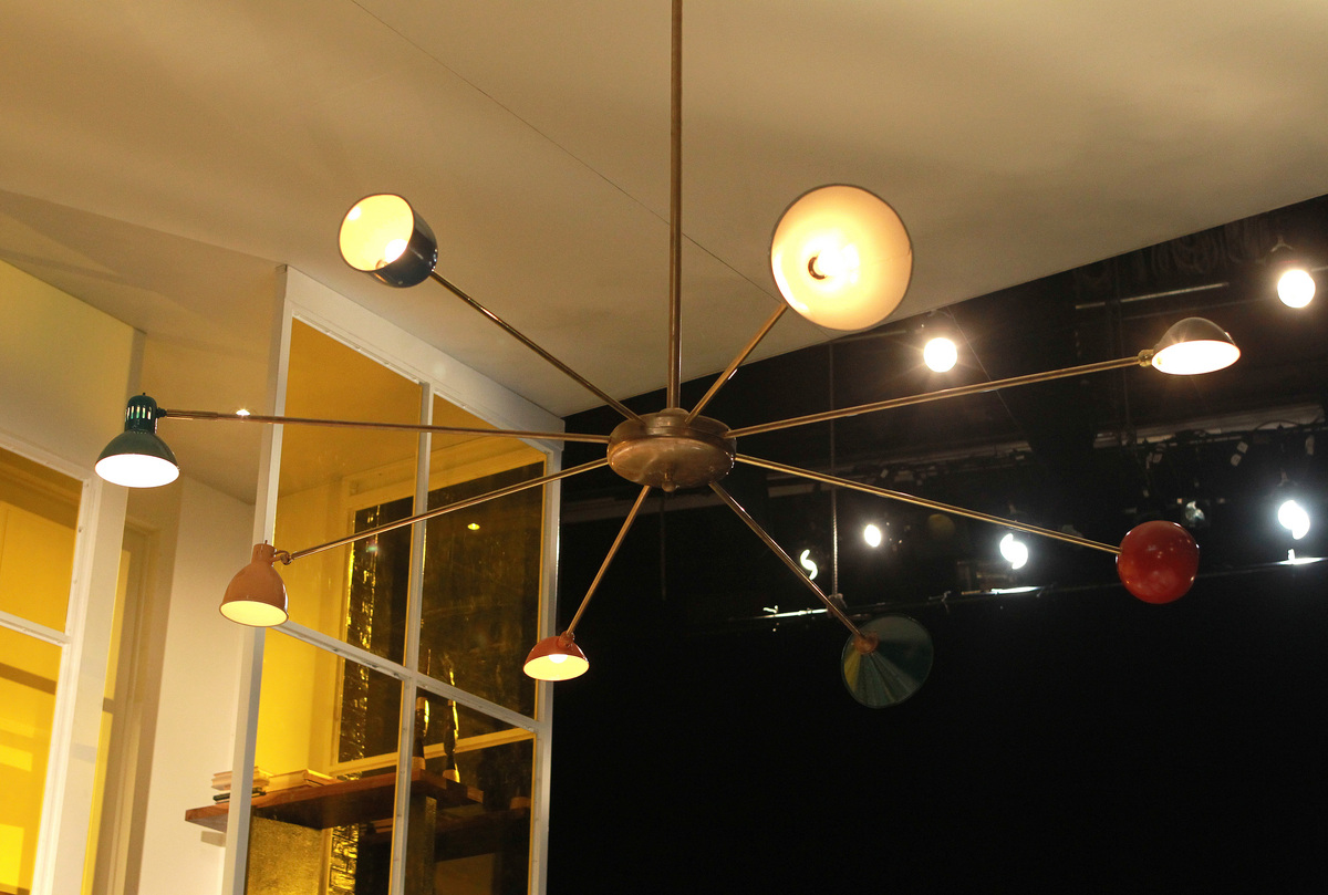 The 8-foot-wide chandelier was made by properties master Kristine Holmes using borrowed lampshades.