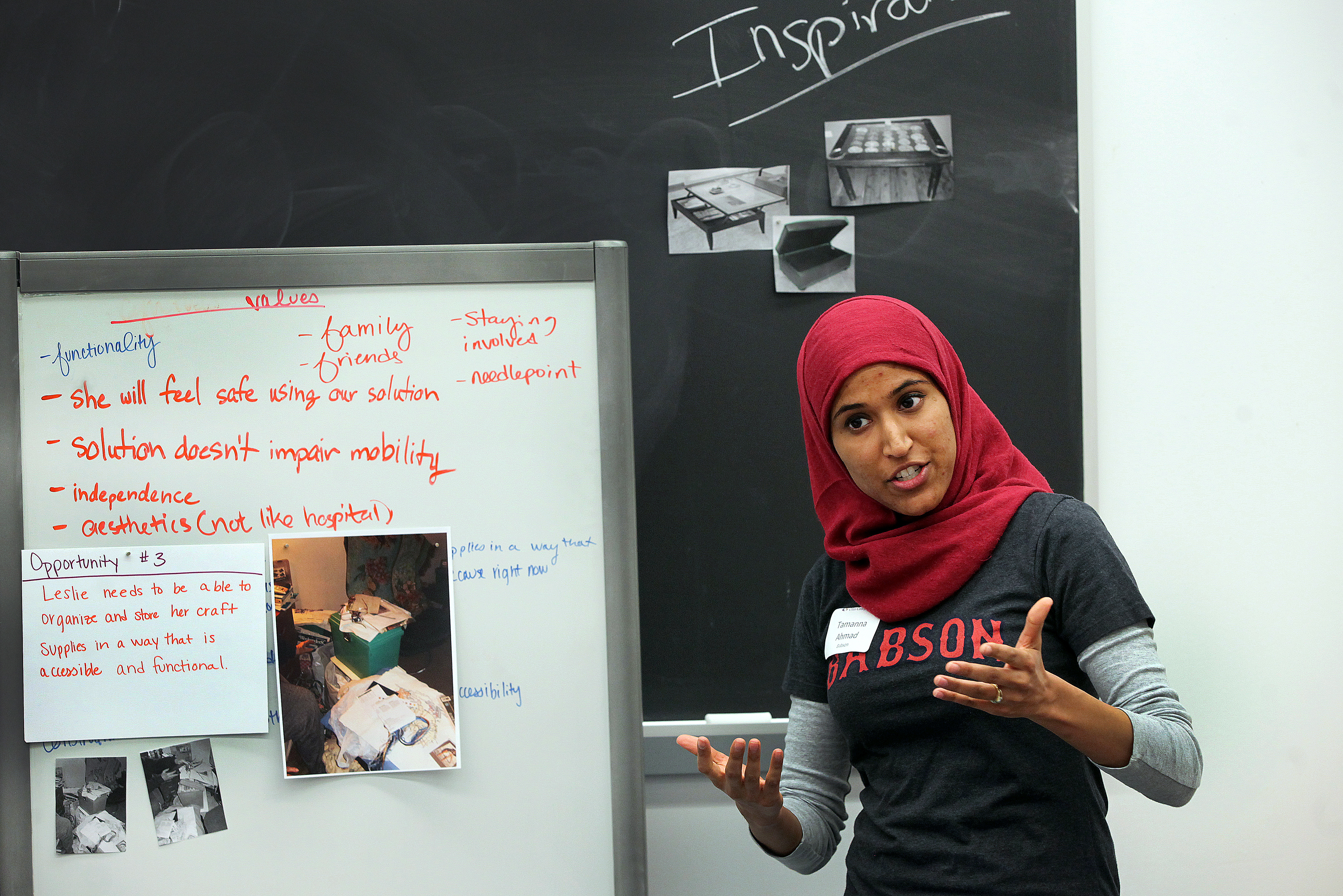 Tamanna Ahmad, 2nd year MBA student student at Babson explains one of her group's opportunities for an assistive divice for senior Leslie Jose.