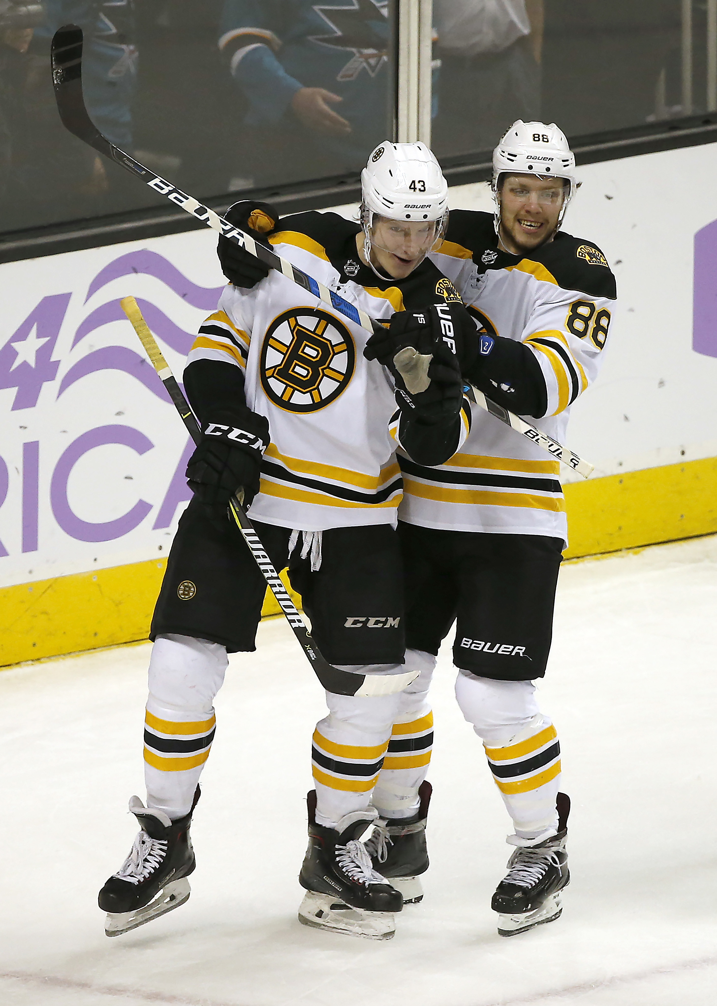 Boston Bruins center Danton Heinen (43) celebrates with David Pastrnak (88) after scoring a goal against the San Jose Sharks.