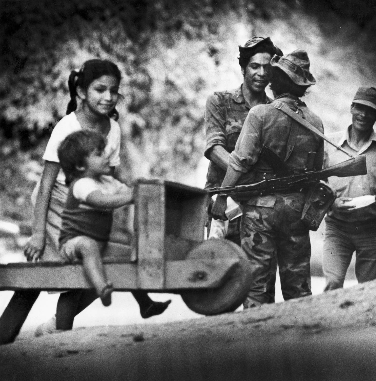Barefoot children played in front of Sandinista soldiers stationed in San Fernando, close the Honduras border in northern Nicaragua, December 1986.
