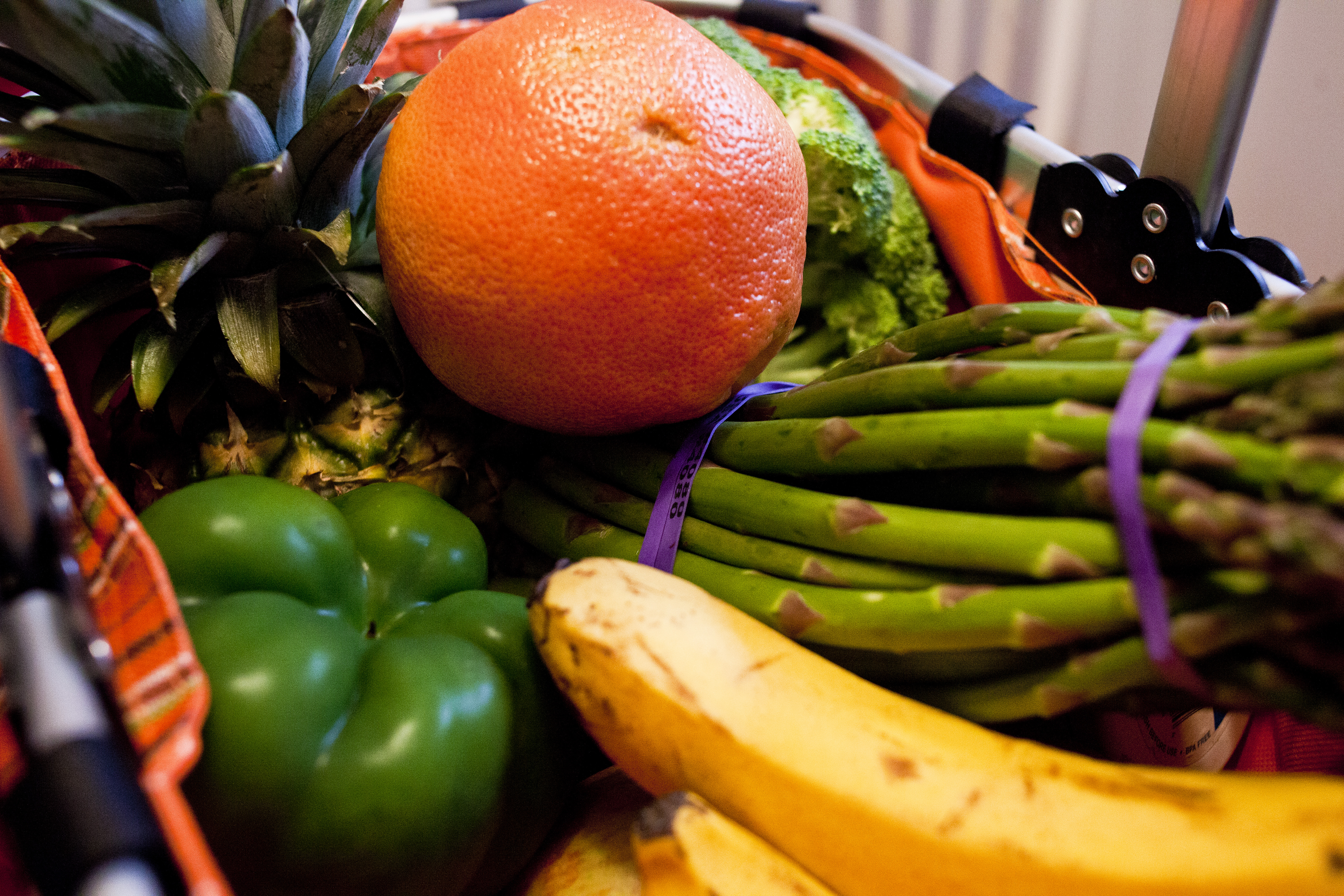 Fresh fruits and vegetables piled up in a grocery basket in Laura Smith’s apartment.