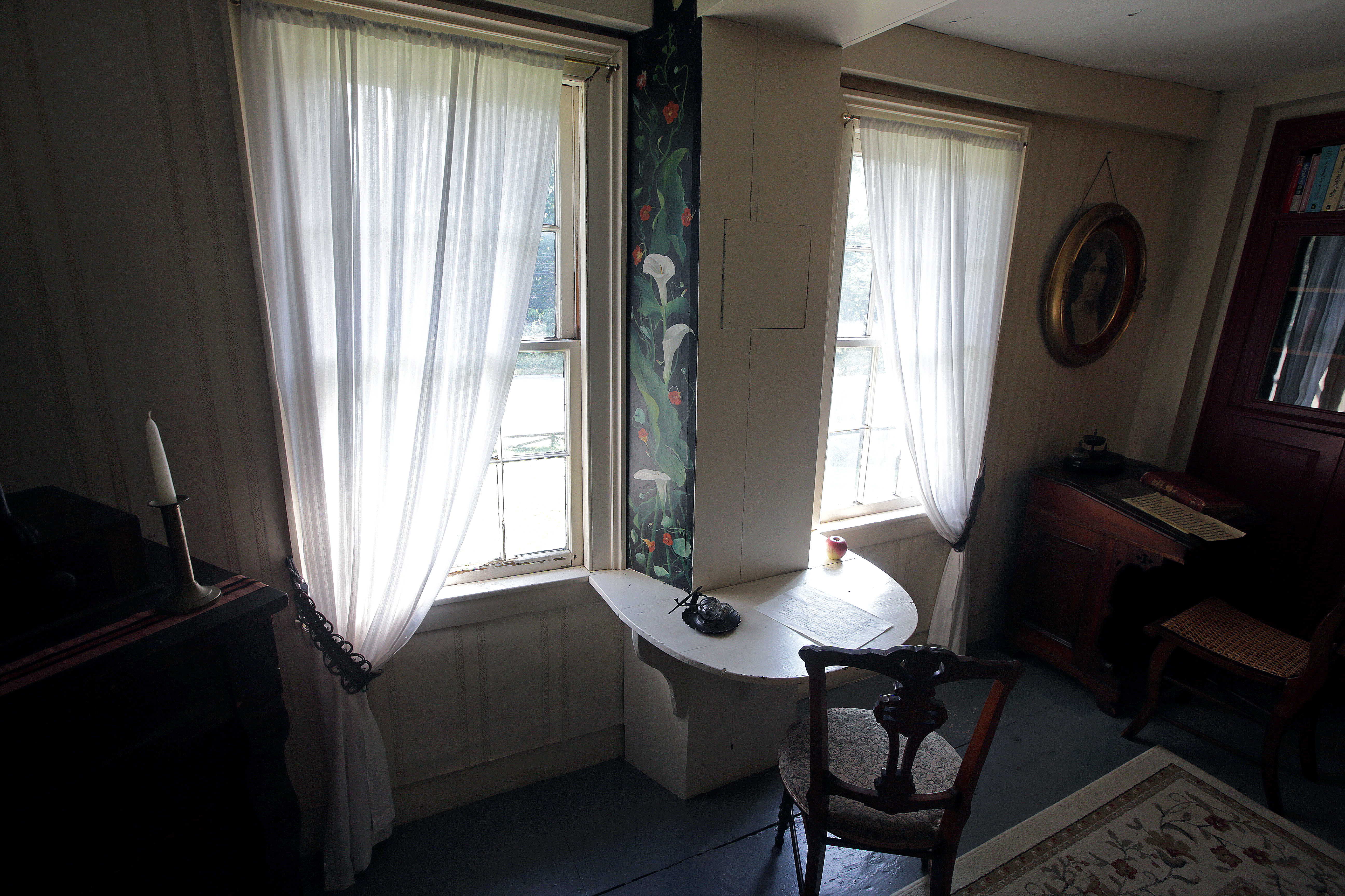 Louisa May Alcott’s father, Bronson, built this desk where she wrote “Little Women.” Her youngest sister, May, painted a panel of calla lilies and nasturtiums beside the desk to cheer Louisa.