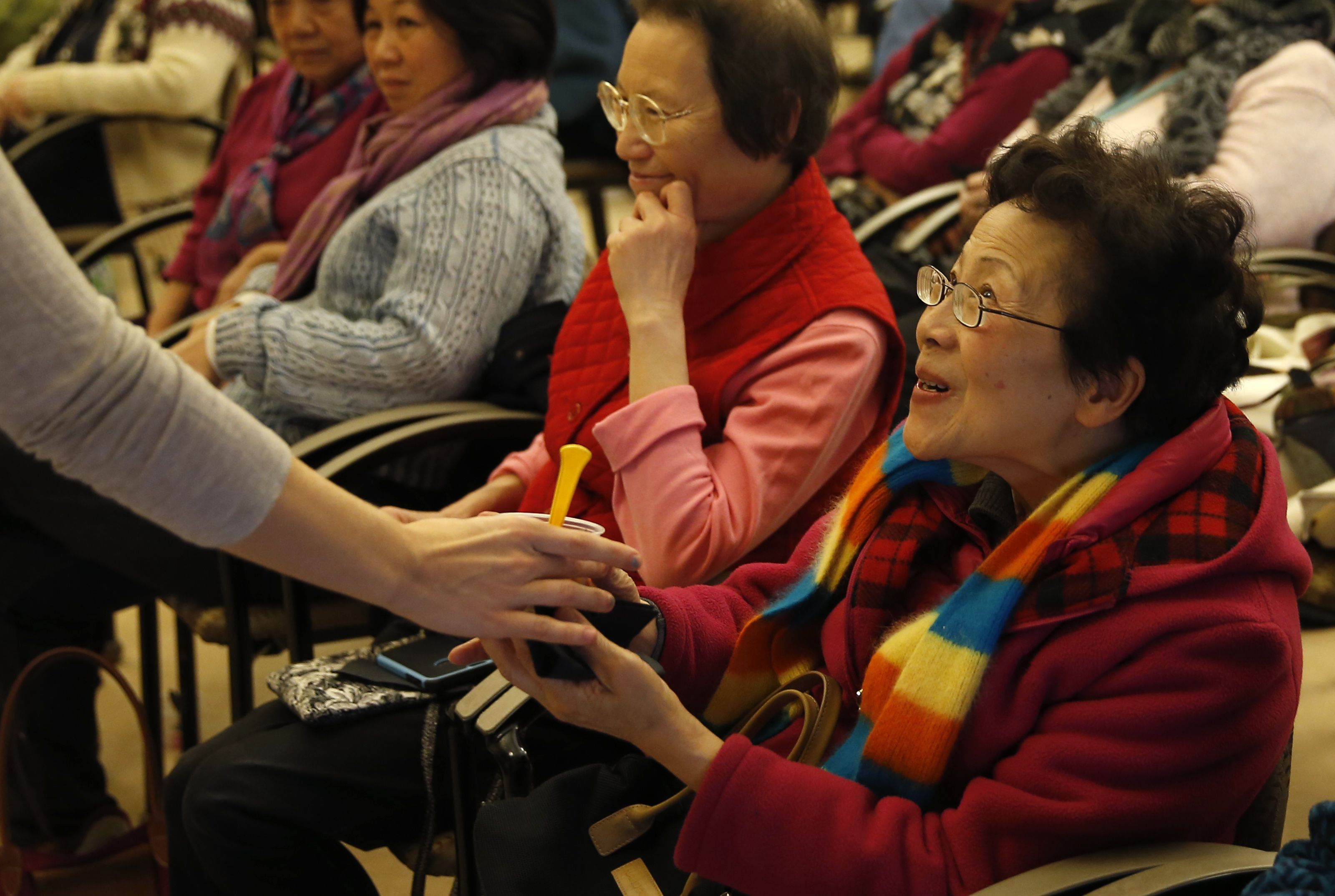 A woman smiled as she took a sample of Chef Irene Li of Mei Mei Kitchen's three bean salad with herbs and spices.