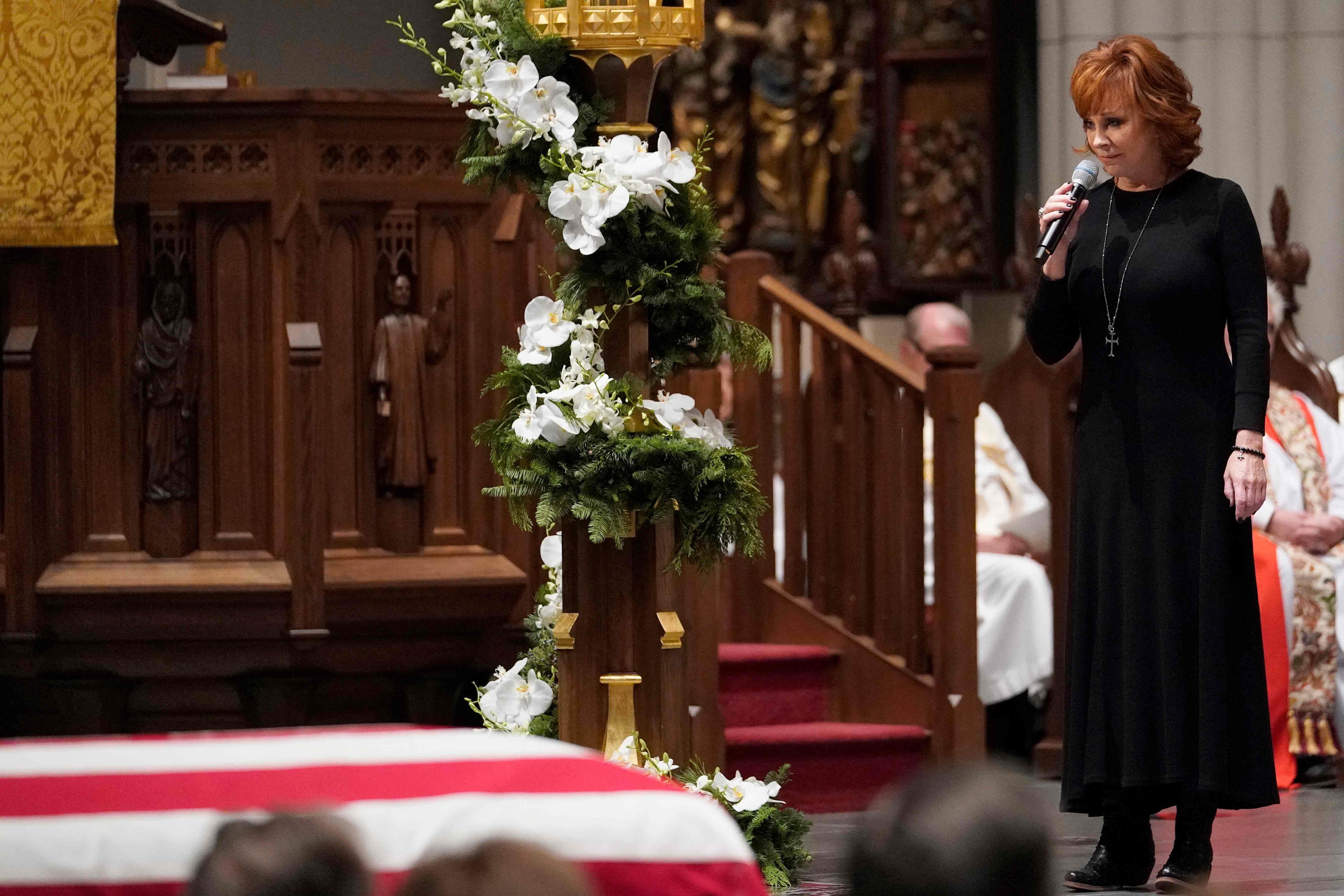 Reba McEntire sings "The Lord's Prayer" during a funeral service.