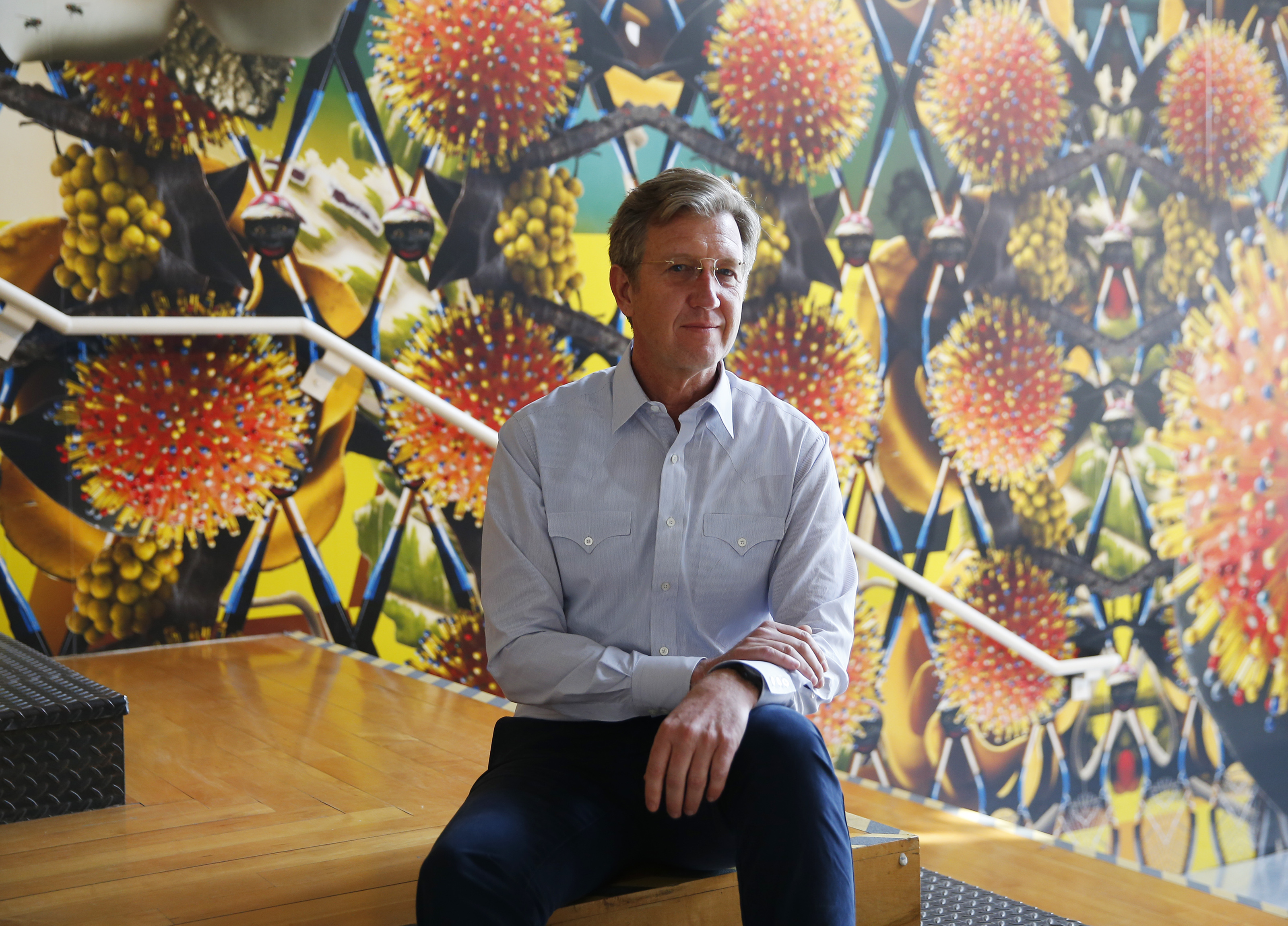 Joseph C. Thompson sits near a piece by Nick Cave.