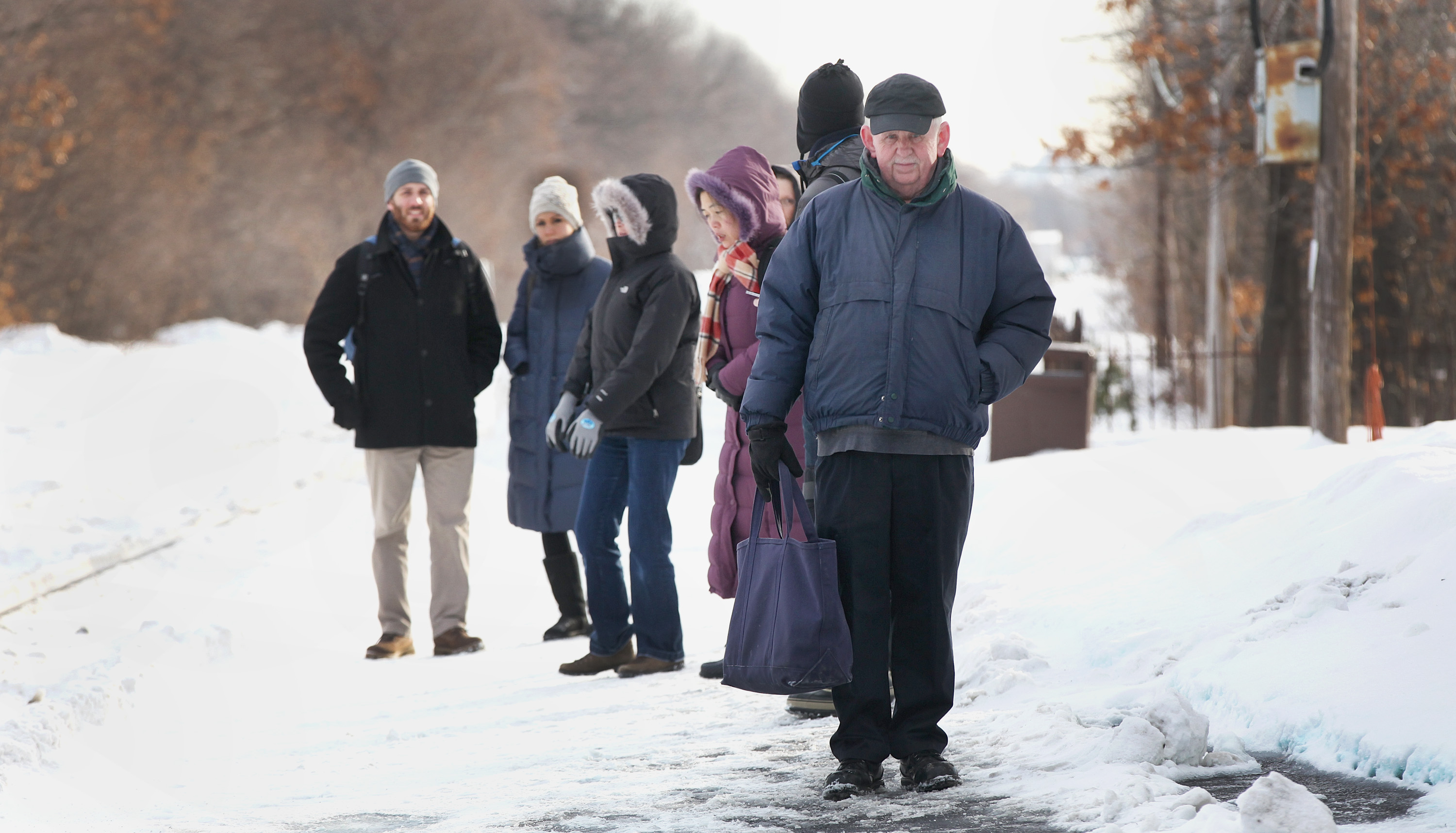 Commuters wait at the rail station in Belmont.
