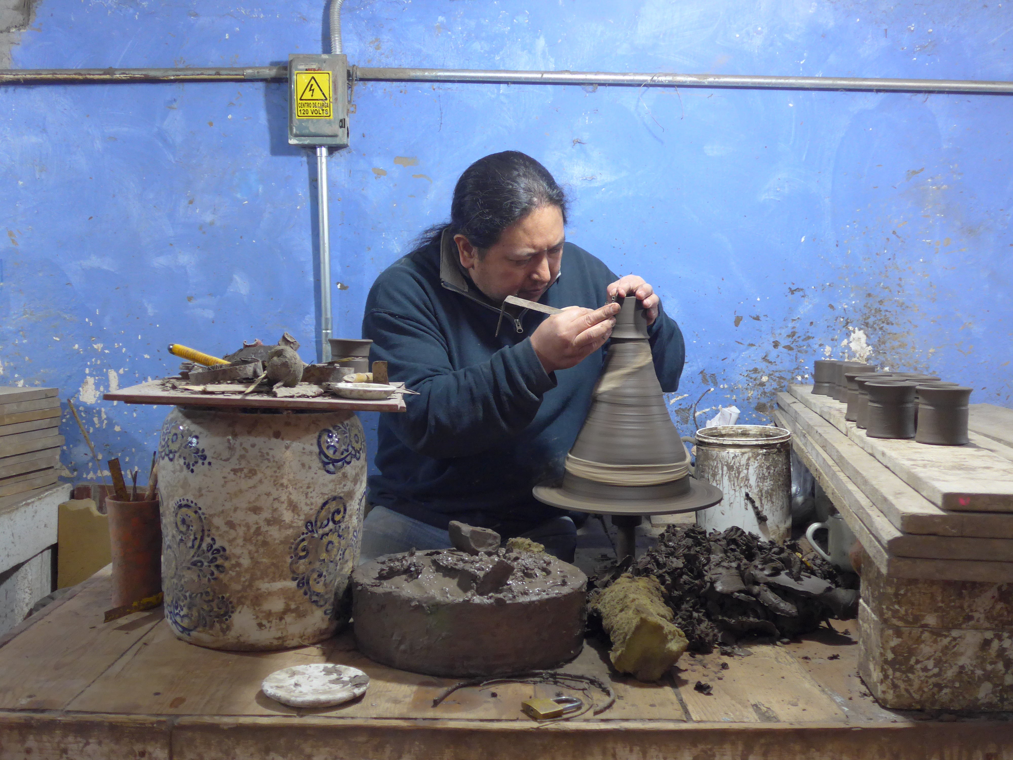 A worker shapes a piece at Uriarte Talavera, a ceramics company started in 1824.