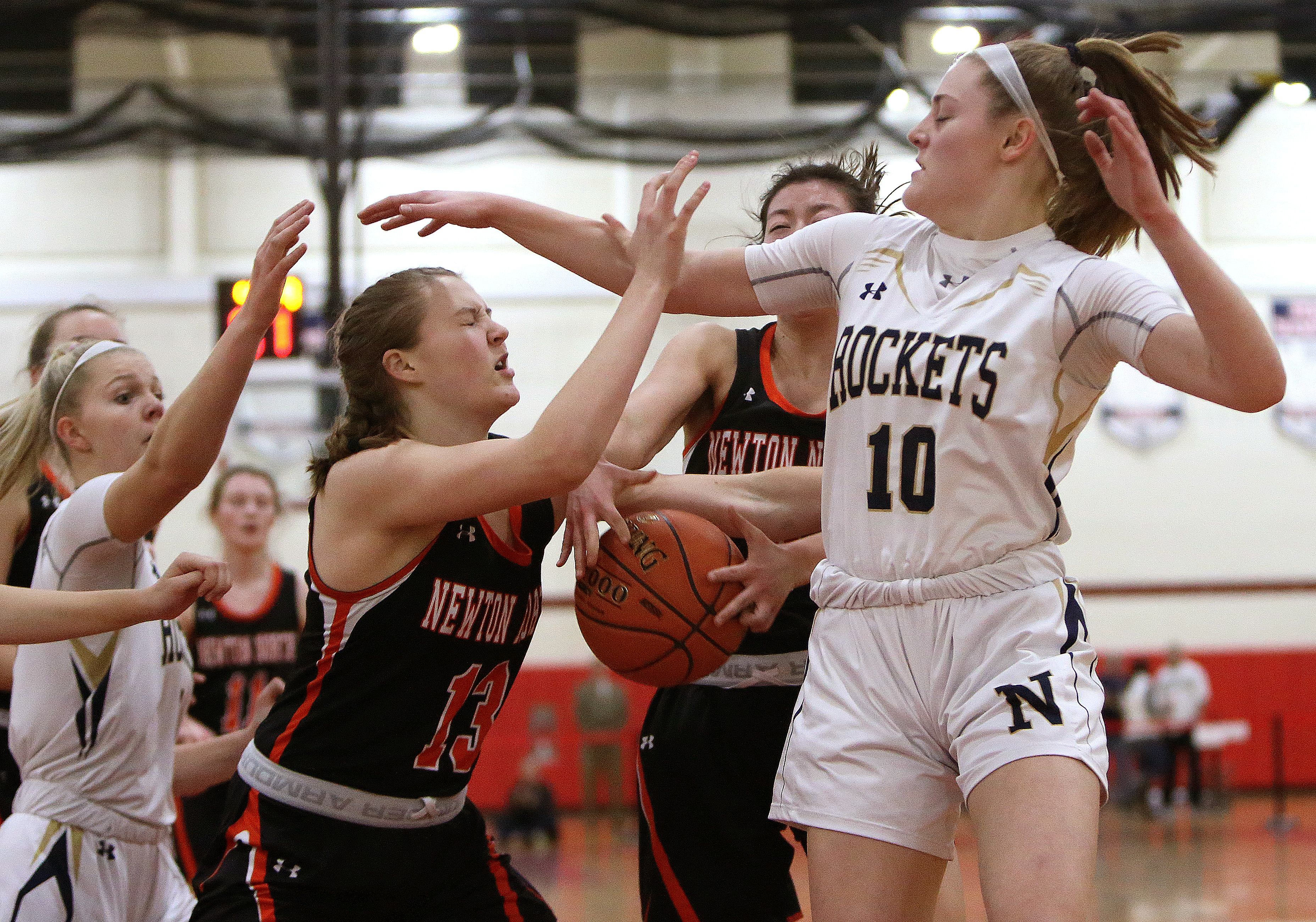 Needham's Avery Johnson (10) goes for the block on Newton North’s Abigail Wright.