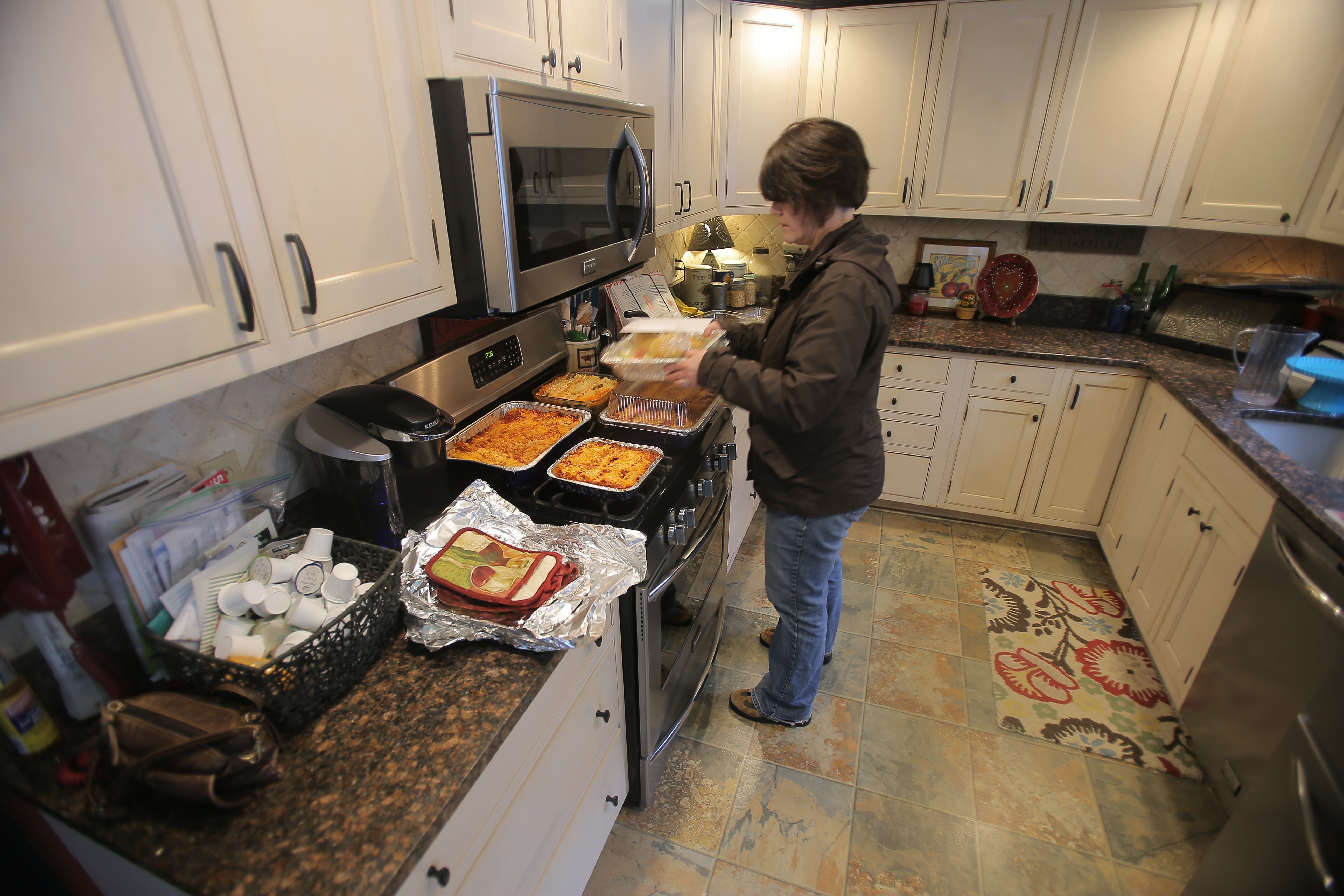 Joanne Stanway prepares containers of lasagna she made.