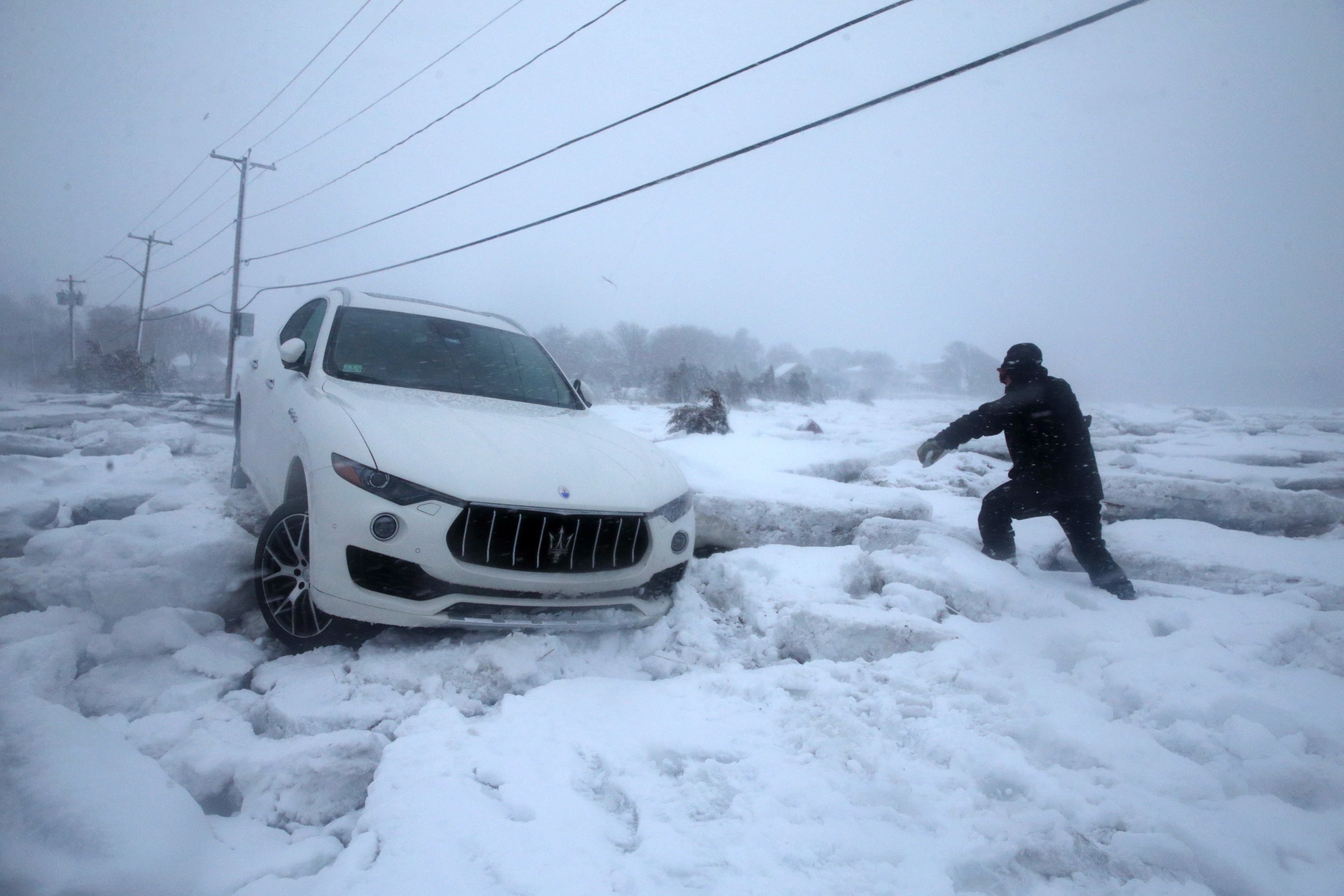 Steve Corsano investigated an abandoned vehicle trapped in sea ice on Bailys Causeway during the storm in Scituate.