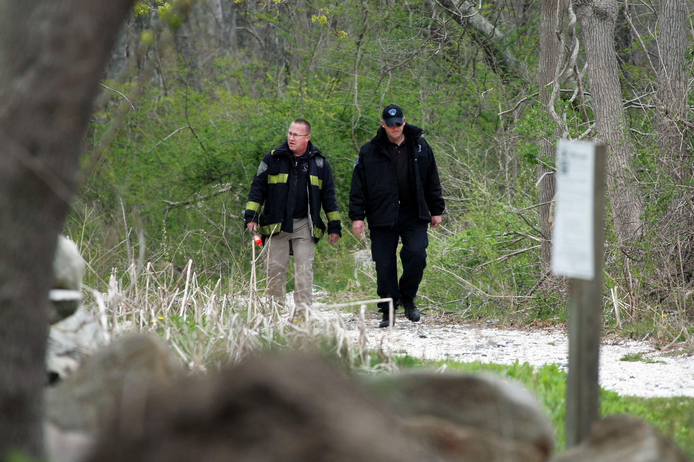 Investigators searched a wooded area in Dartmouth Friday.