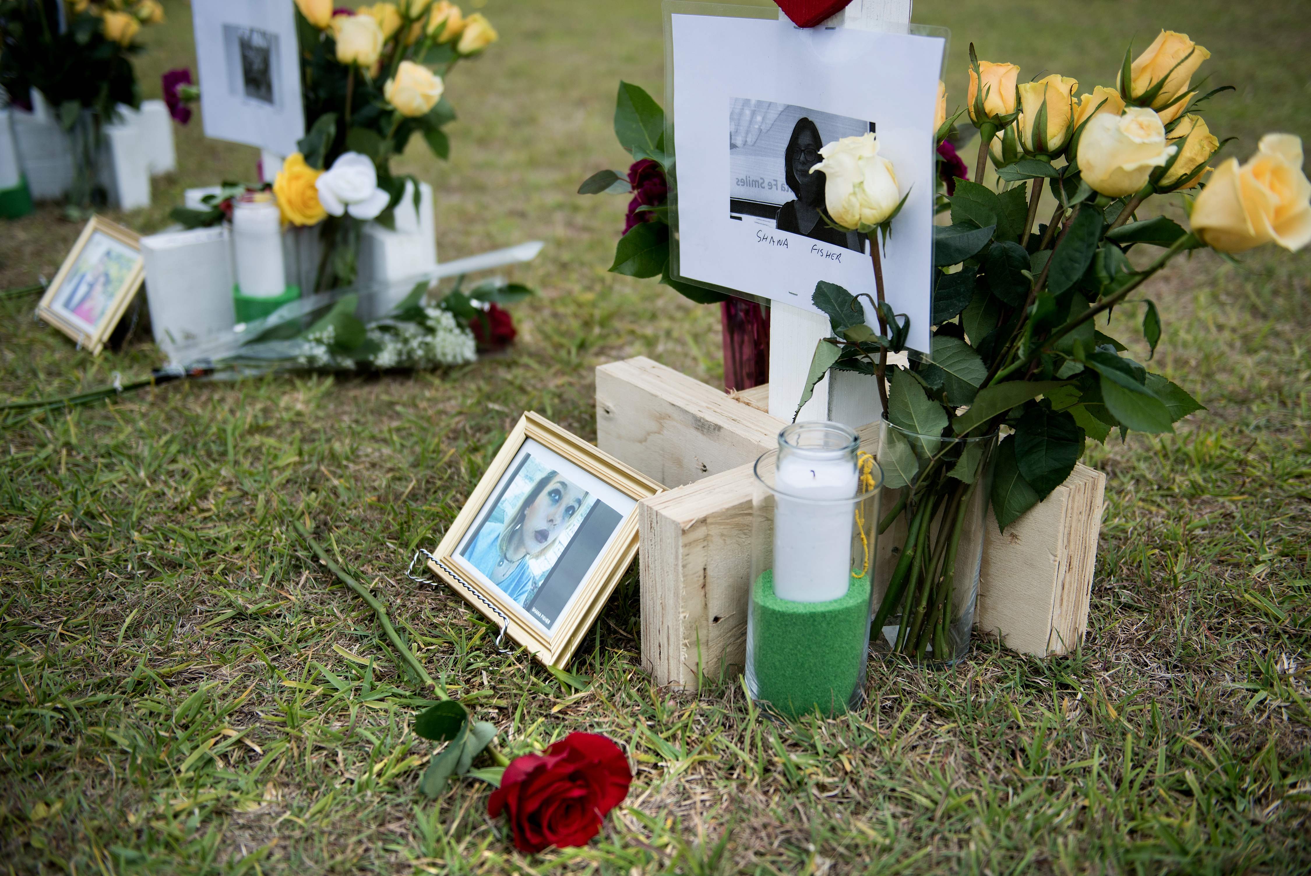 A cross for Shana Fisher was seen at a memorial for the victims.