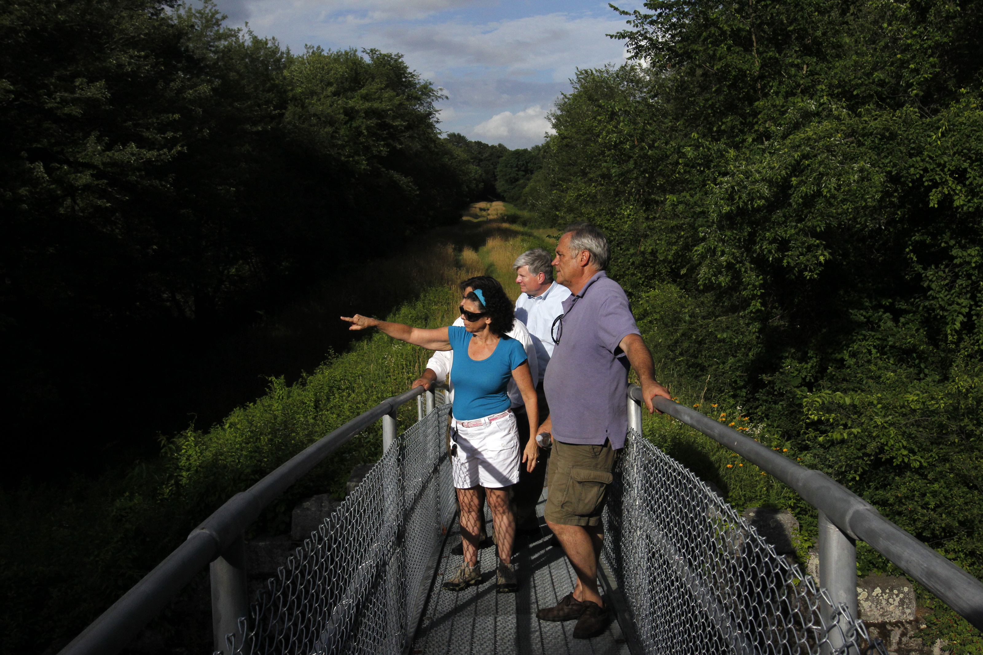 Framingham Selectwoman Laurie Lee with executive director of the MWRA Fred Laskey and state Representative Chris Walsh along a section of the aqueduct that will be opened to the public.