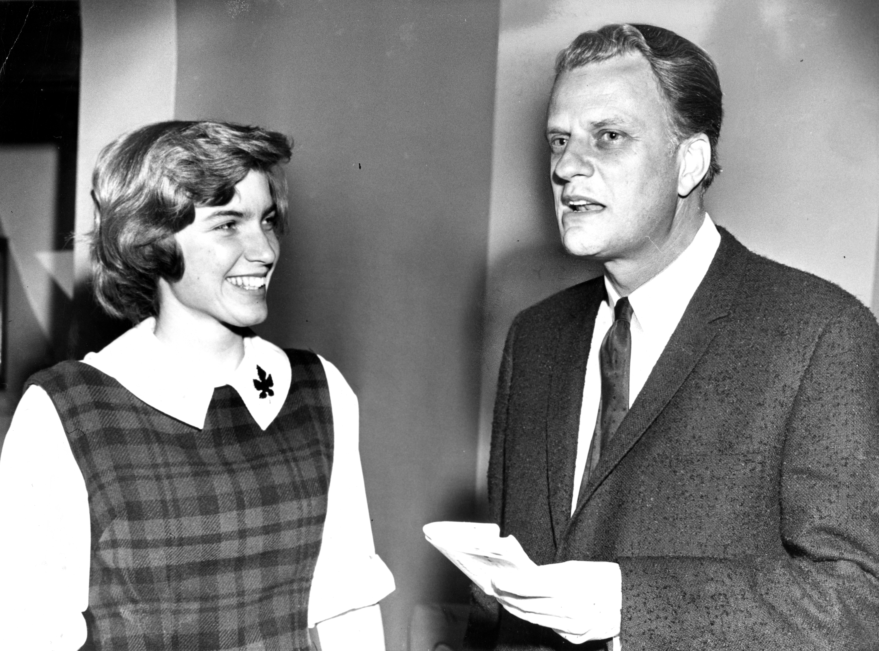 Evangelist Billy Graham with Betsy Loutrel of Cincinnati, OH, chairman of a meeting sponsored by the Wellesley Christian Fellowship at Wellesley College in Wellesley, MA on Feb. 17, 1964.